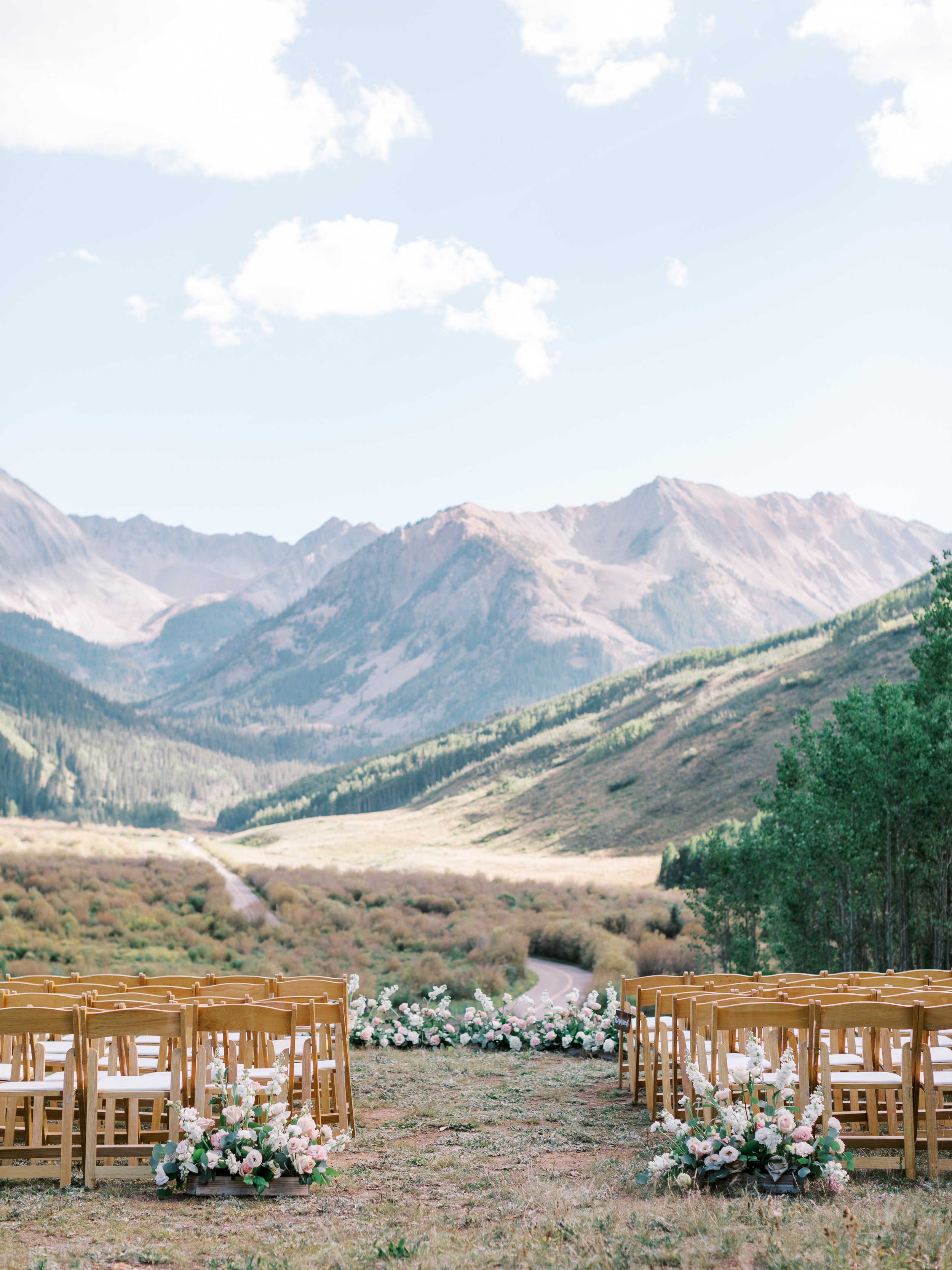 a breathtaking view of the mountains in this outdoor ceremony venue in aspen colorado.