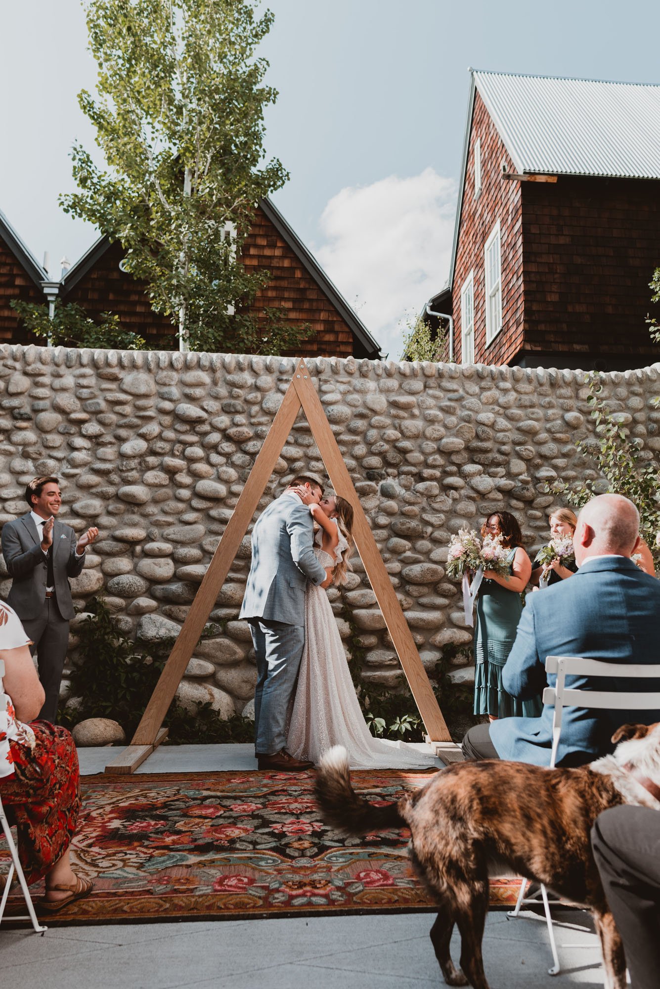 rustic and bohemian colorado wedding ceremony with a triangle alter and vintage rugs.