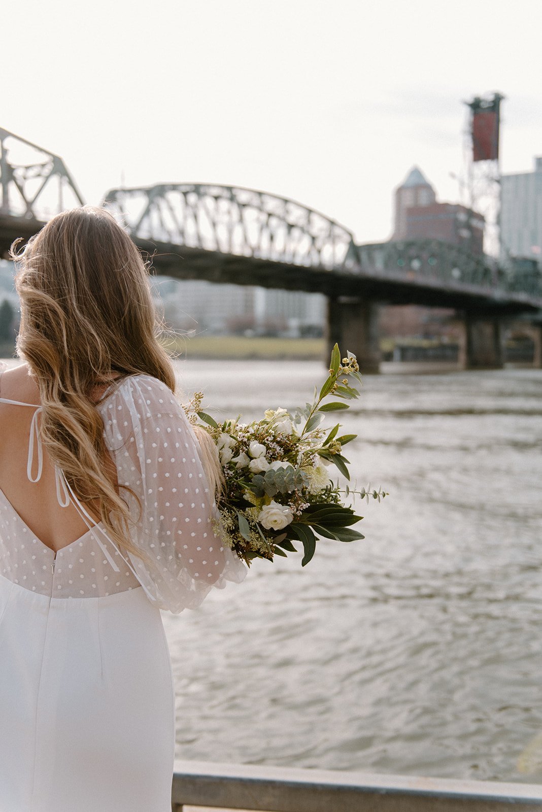 a rose and williams long sleeve embroidered dotted wedding dress in a downtown city styled wedding shoot.