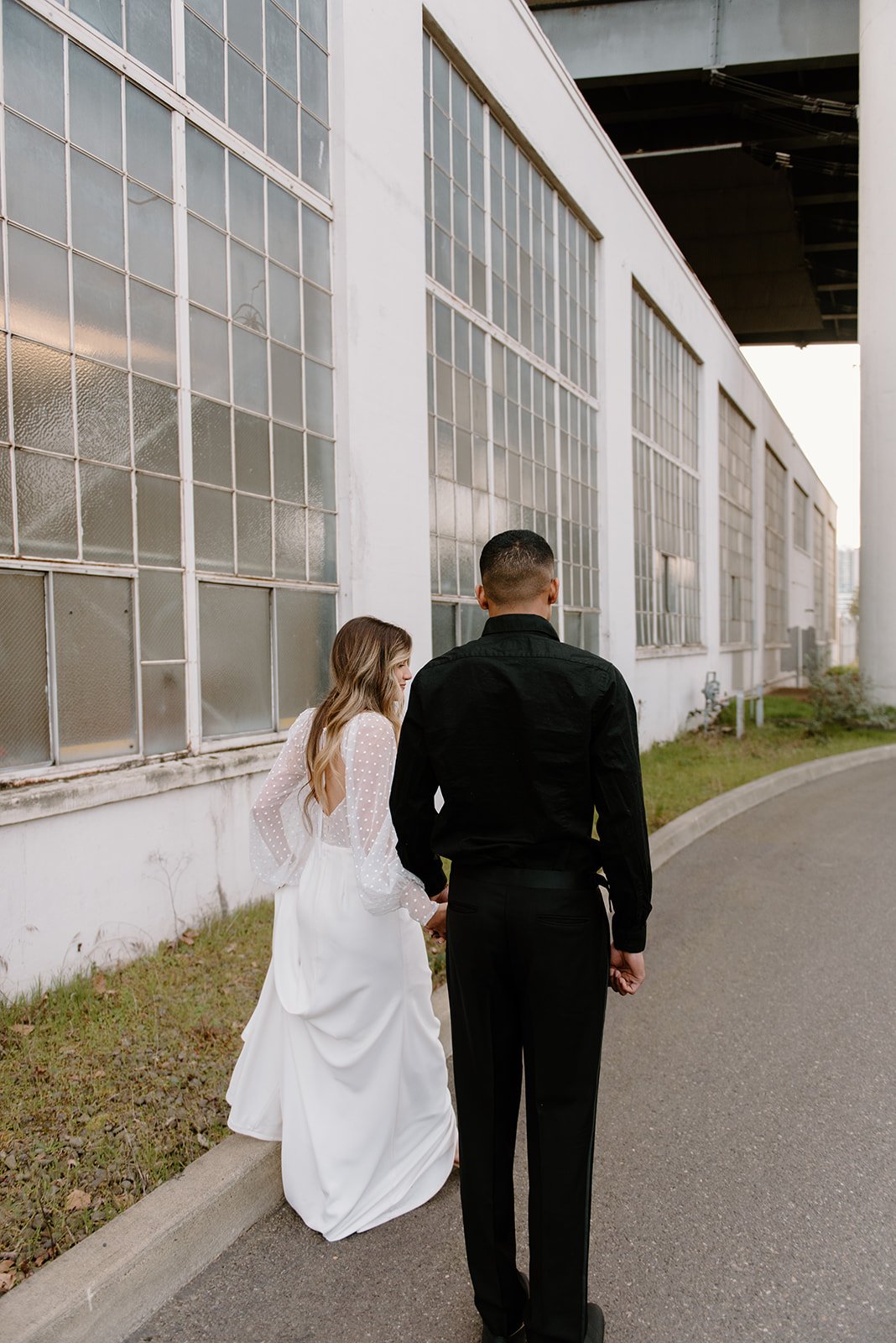 a portland styled wedding shoot with a sheer bodice wedding dress and crepe skirt in a downtown setting.