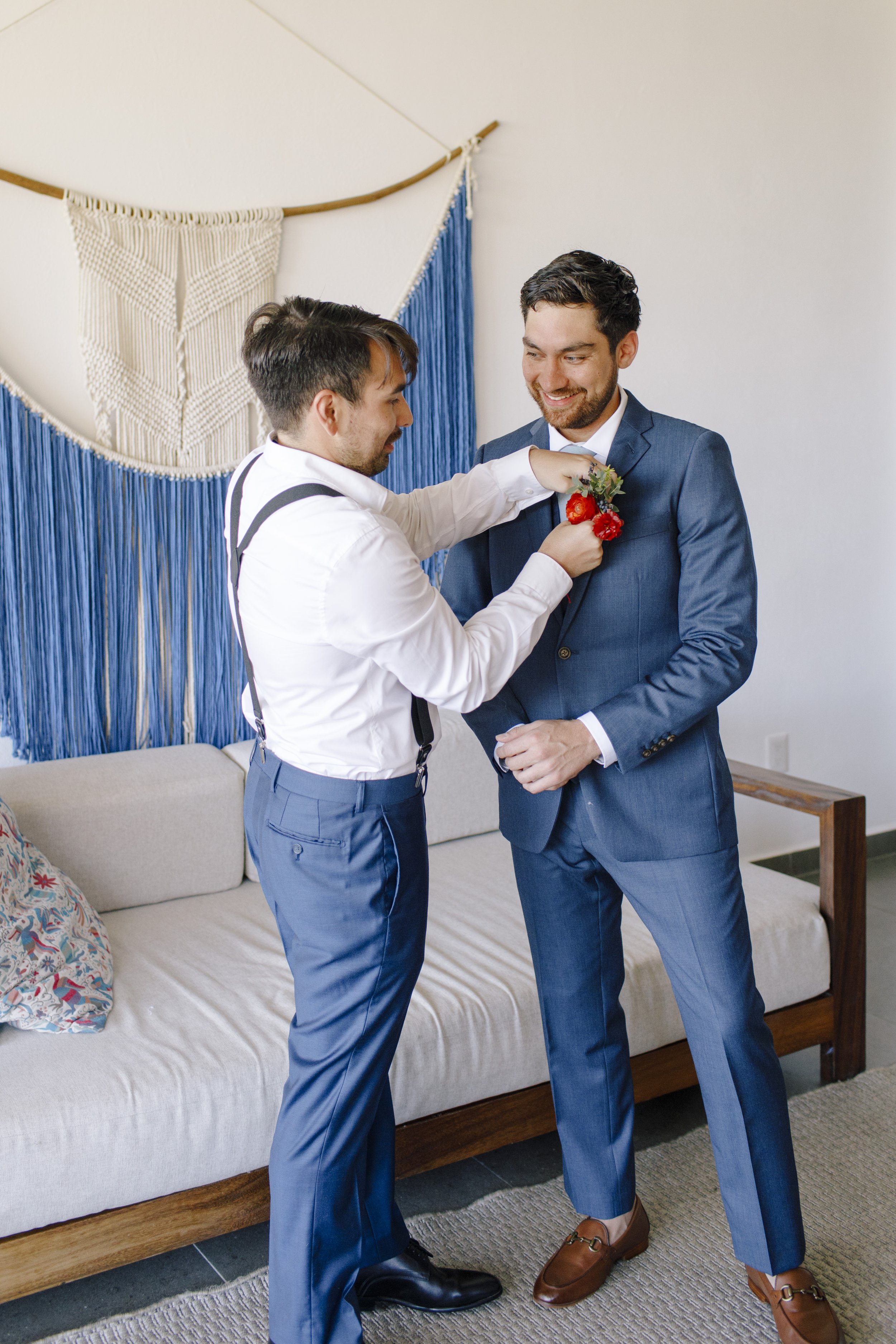 unique groom in a boho setting wearing a blue suit.