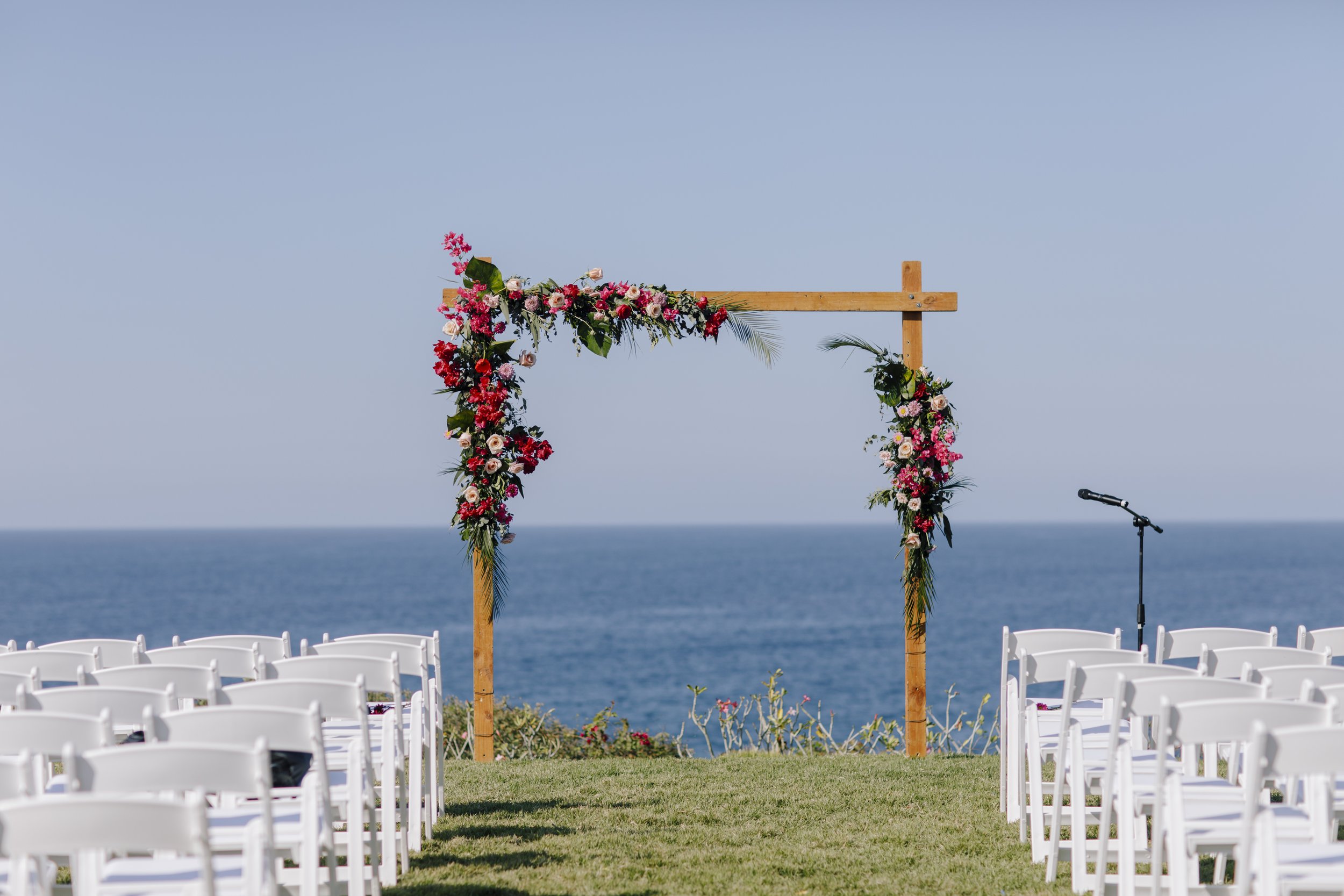 bright and colorful wedding ceremony arch outside in this destination wedding.