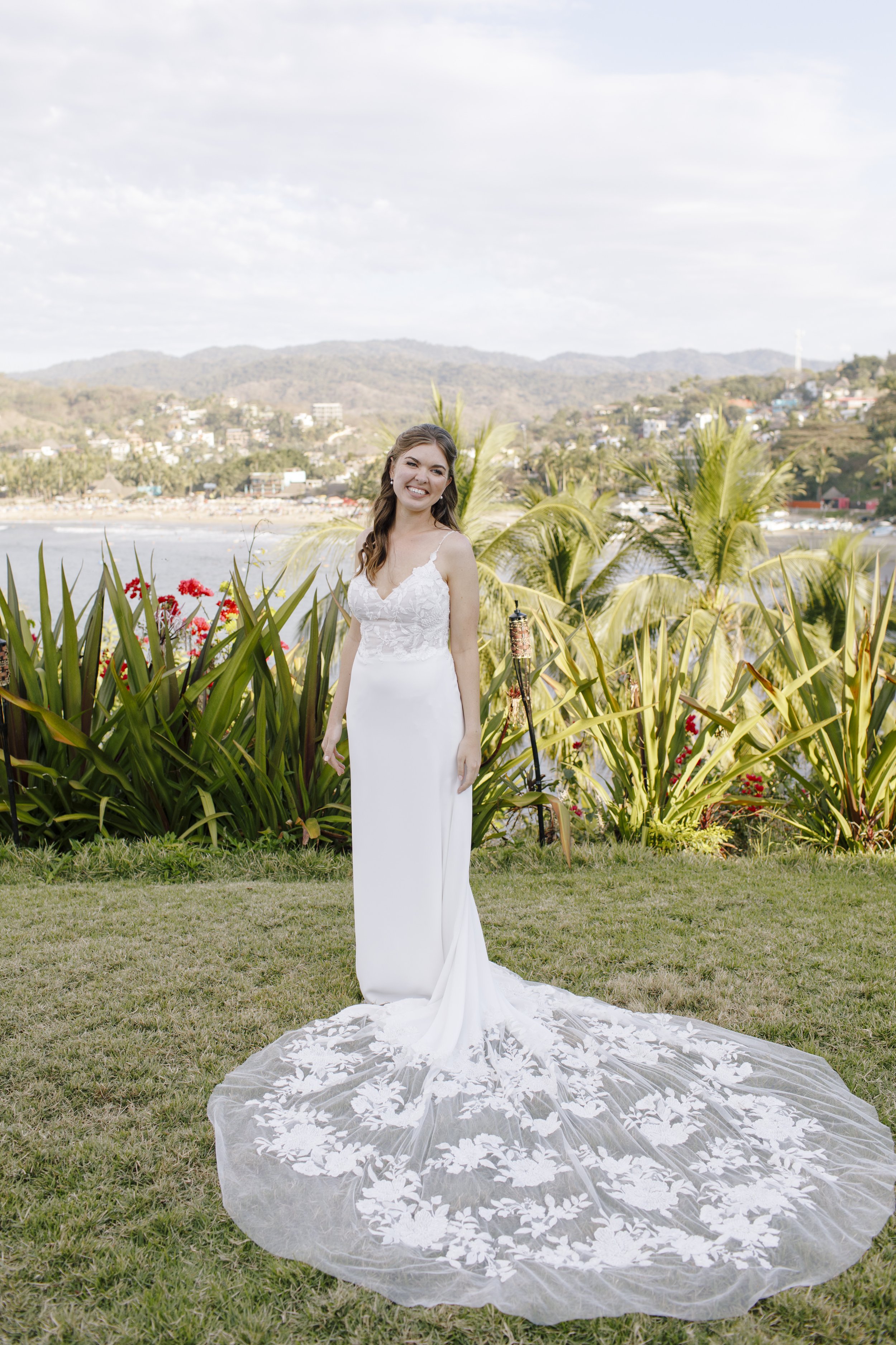 bridal portrait outside on a cliff overlooking the ocean in mexico featuring the wedding gown garden rose by alena leena.