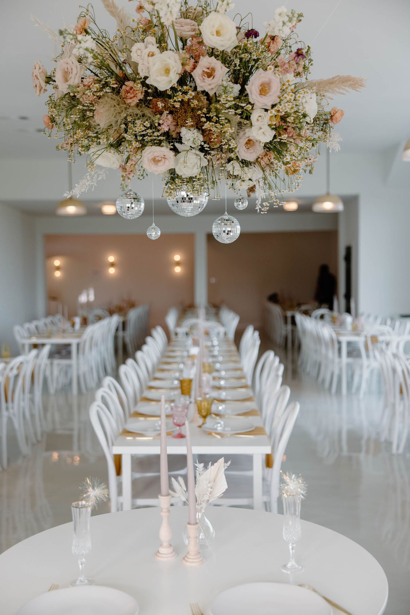 a modern and bright wedding venue called the emerson in texas with clear acrylic chairs and bright modern florals.
