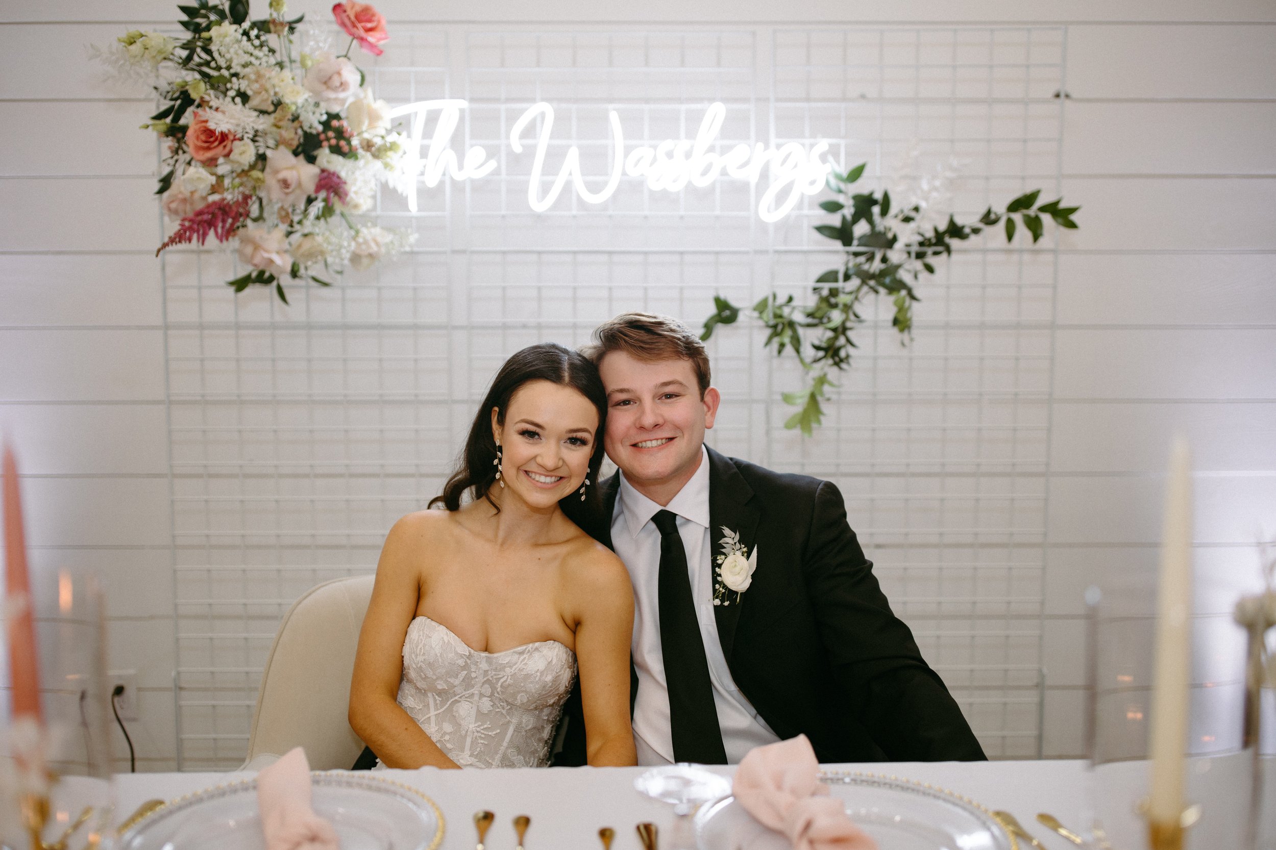 neon sign backdrop at this modern wedding reception.
