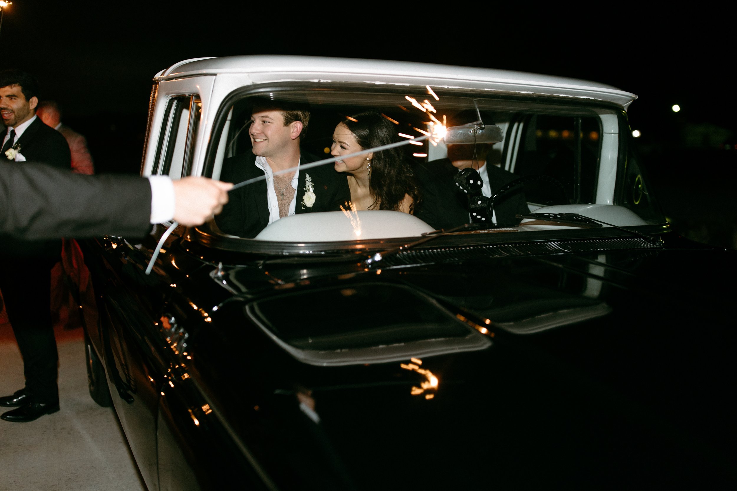 a classic car and sparkler exit at this modern and bright wedding at the gardenia wedding venue.