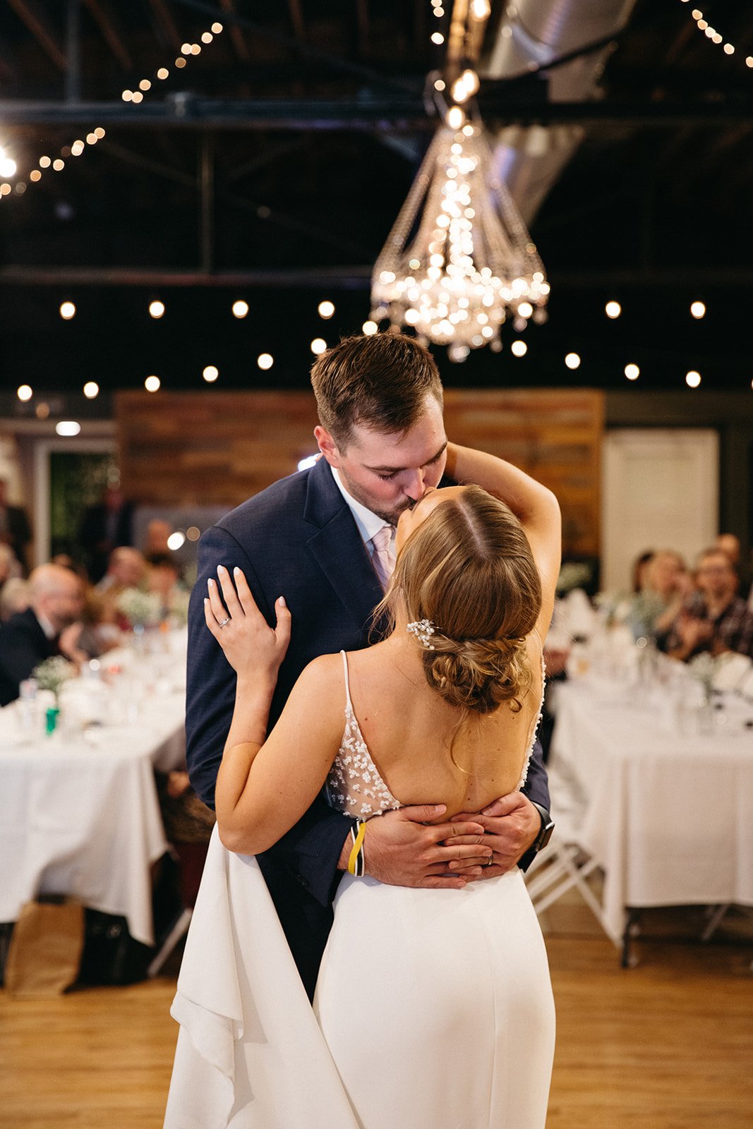 a rustic nebraska wedding venue featuring a simple and chic anais anette crepe wedding dress with beaded details