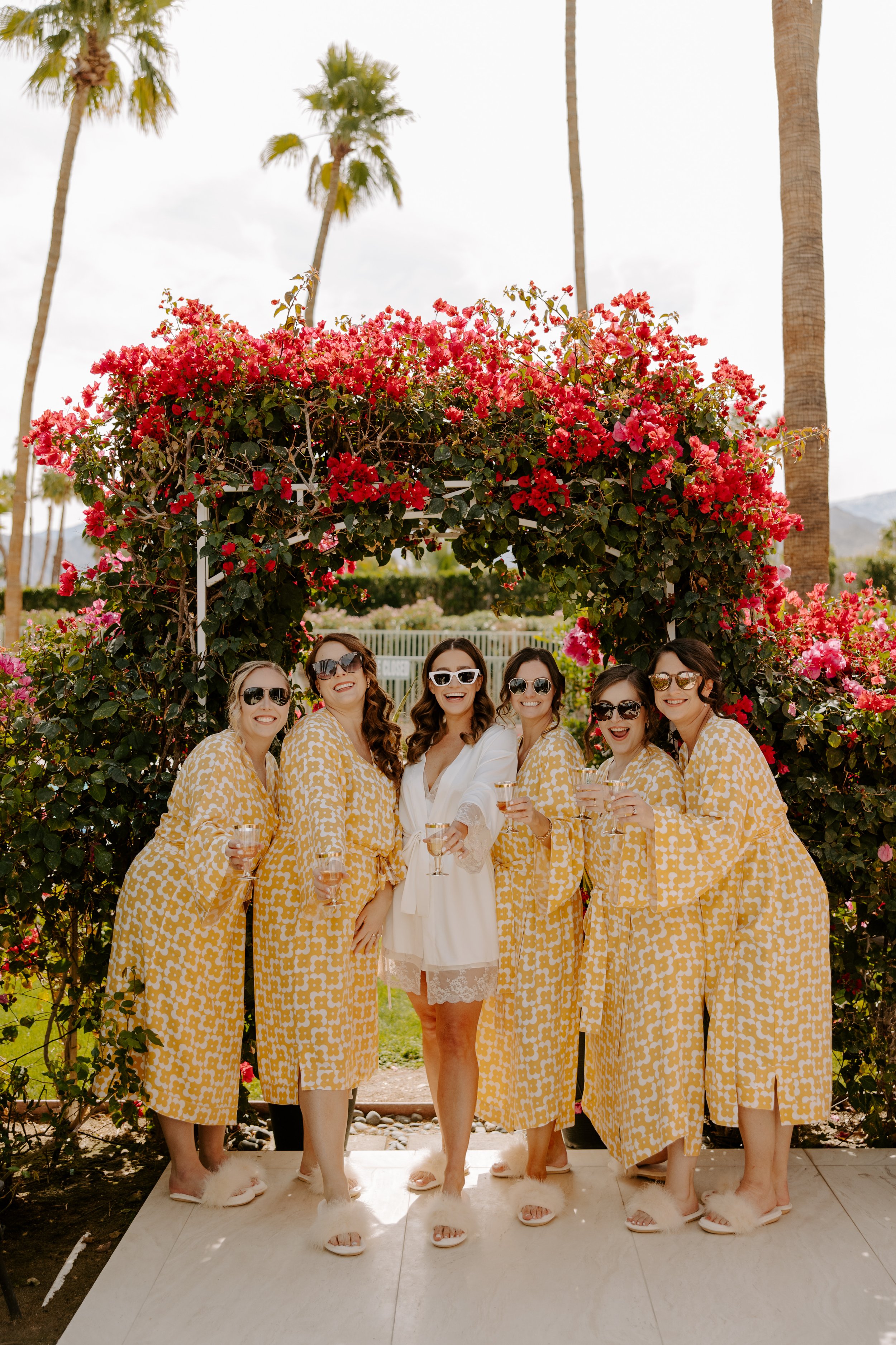 bridesmaids and the bride in a lush outdoor setting in palm springs