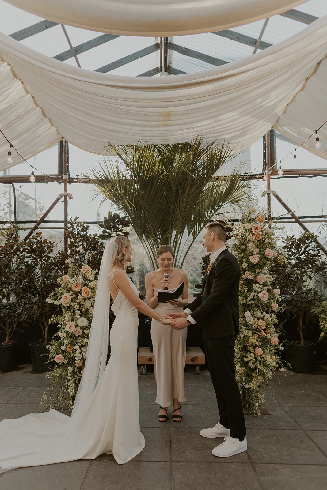 a chic modern wedding in a greenhouse featuring archie by made with love on a real aandbe bride