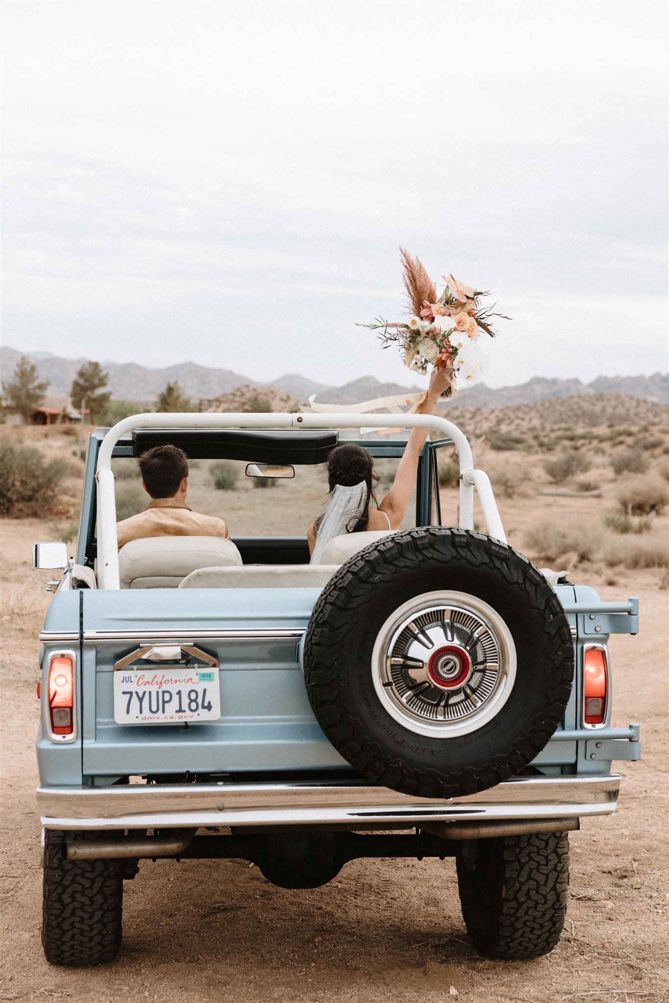 jeep getaway car at the end of the wedding in this desert boho wedding