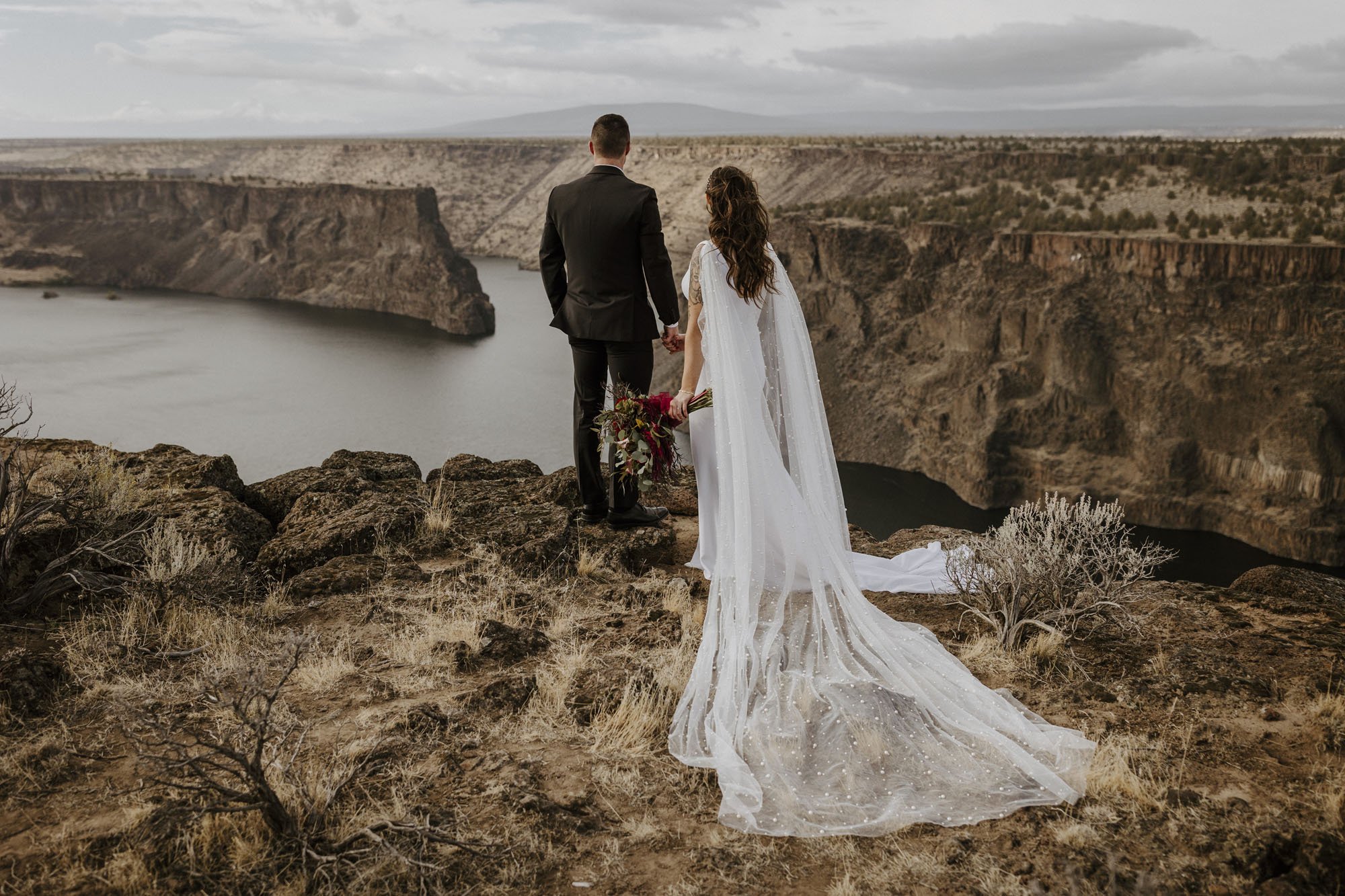 desert cliffside wedding ceremony in simple crepe alyssa kristin wedding dress