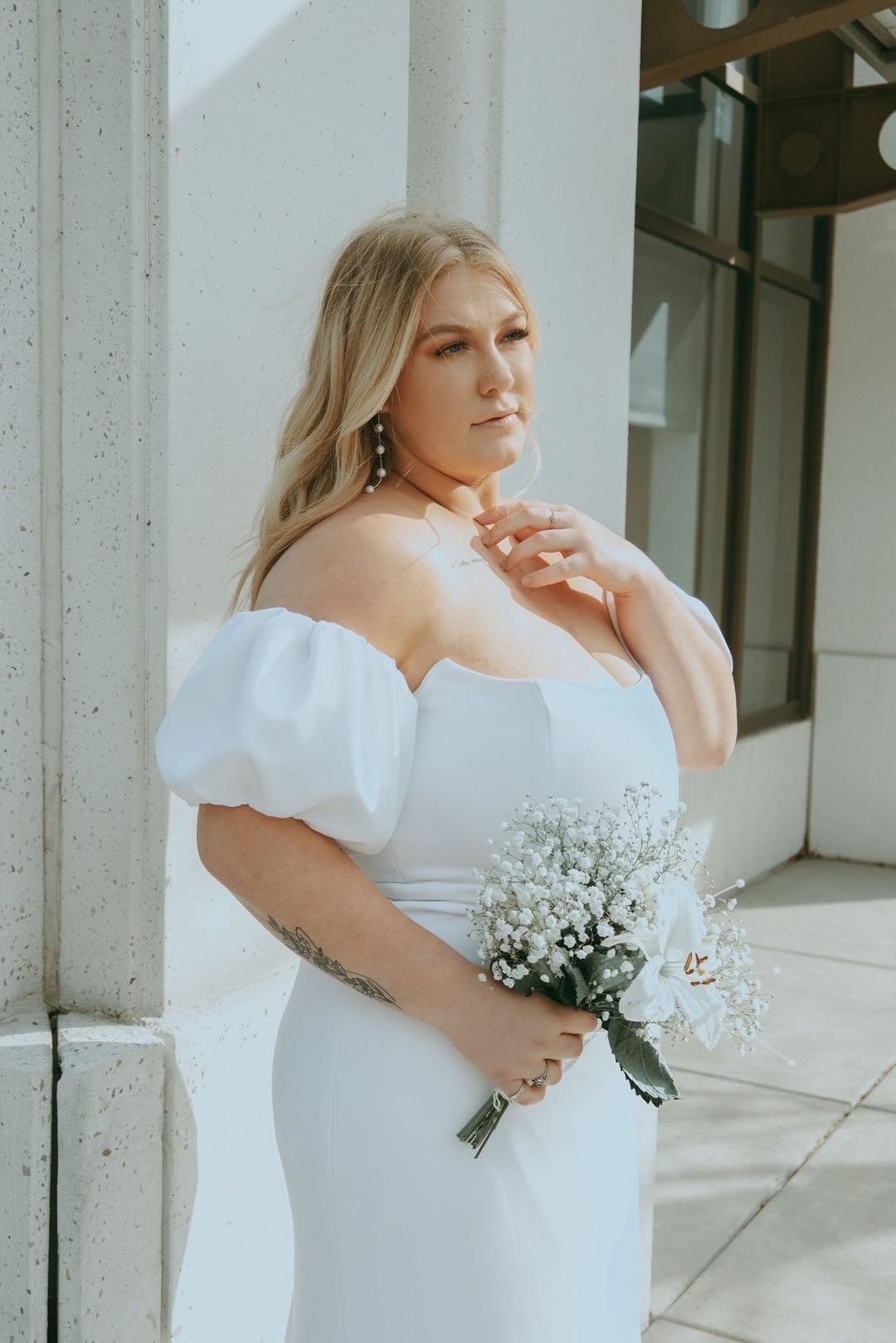 an optional puff sleeve crepe wedding dress by alyssa kristin on an inclusive size model