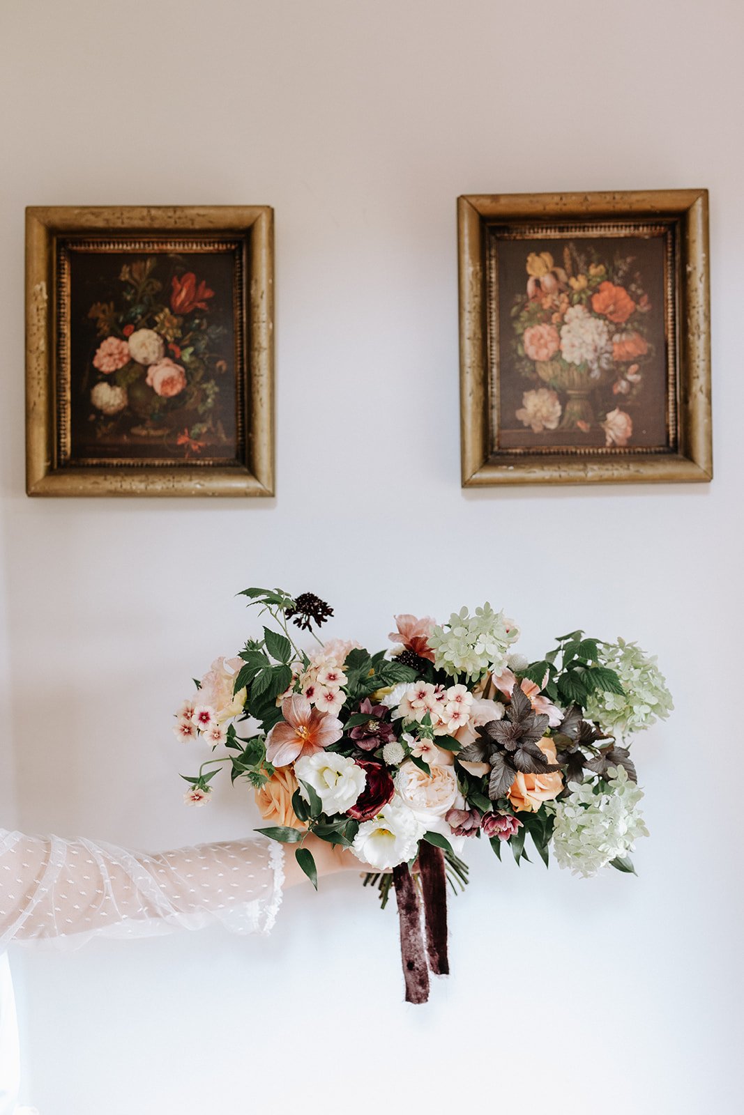 a chic bouquet photo with vintage paintings in the background