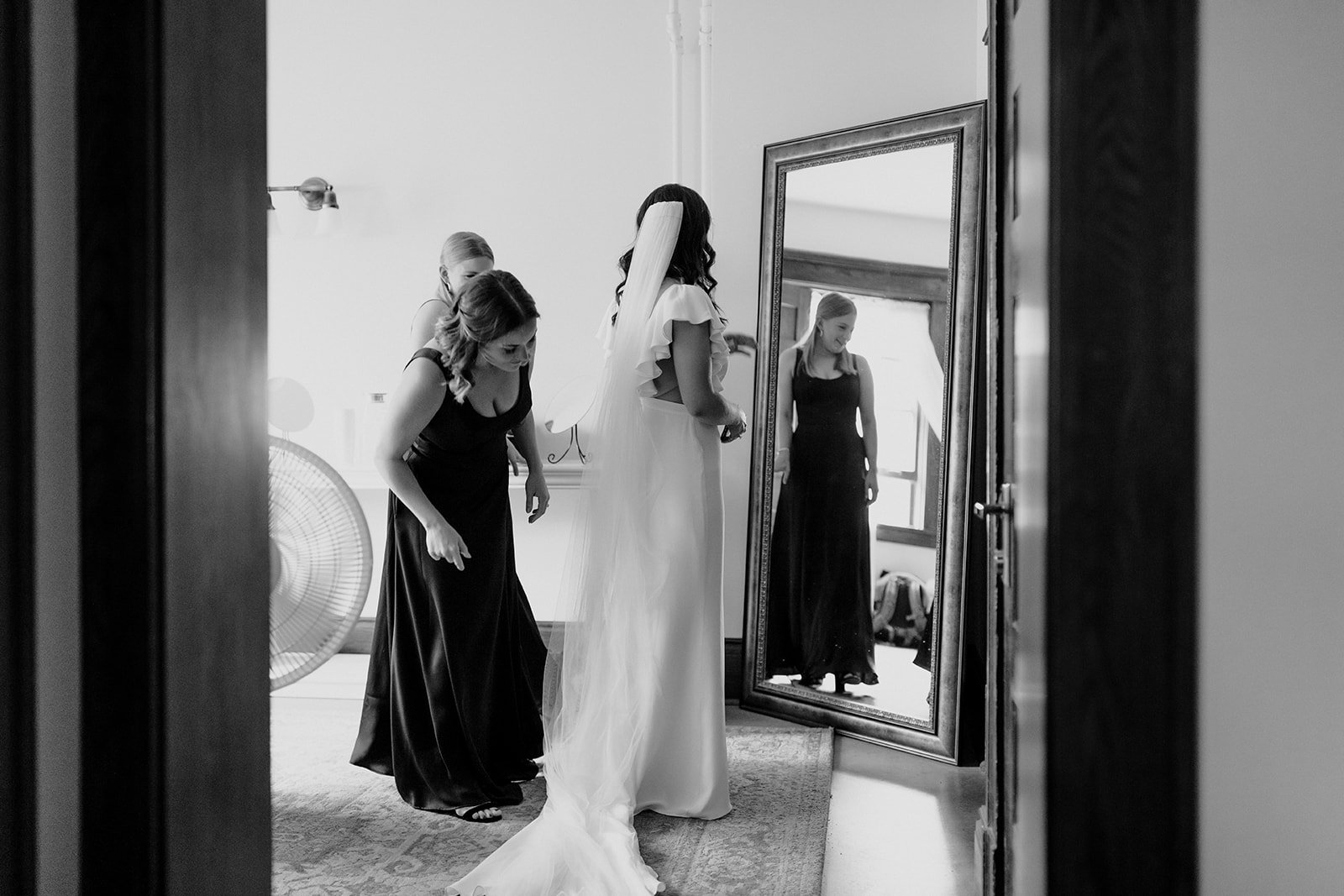 the bride getting ready with bridesmaids in this classic black and white image