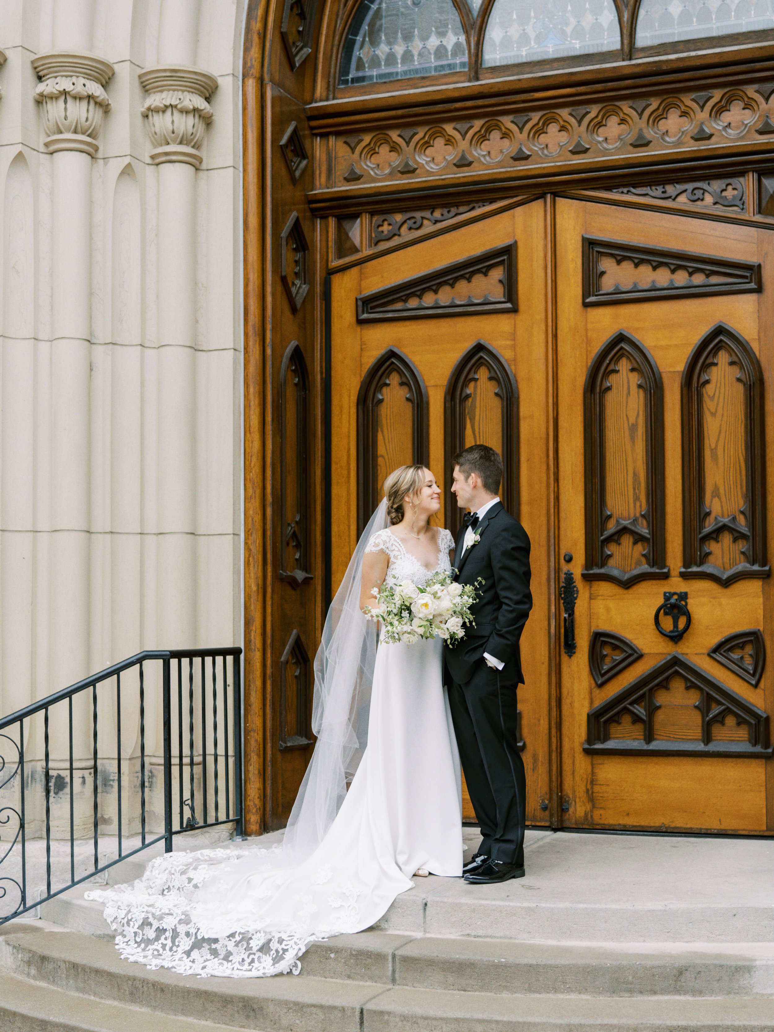 a church wedding with a classic bride and groom portrait in front of the church before the ceremony