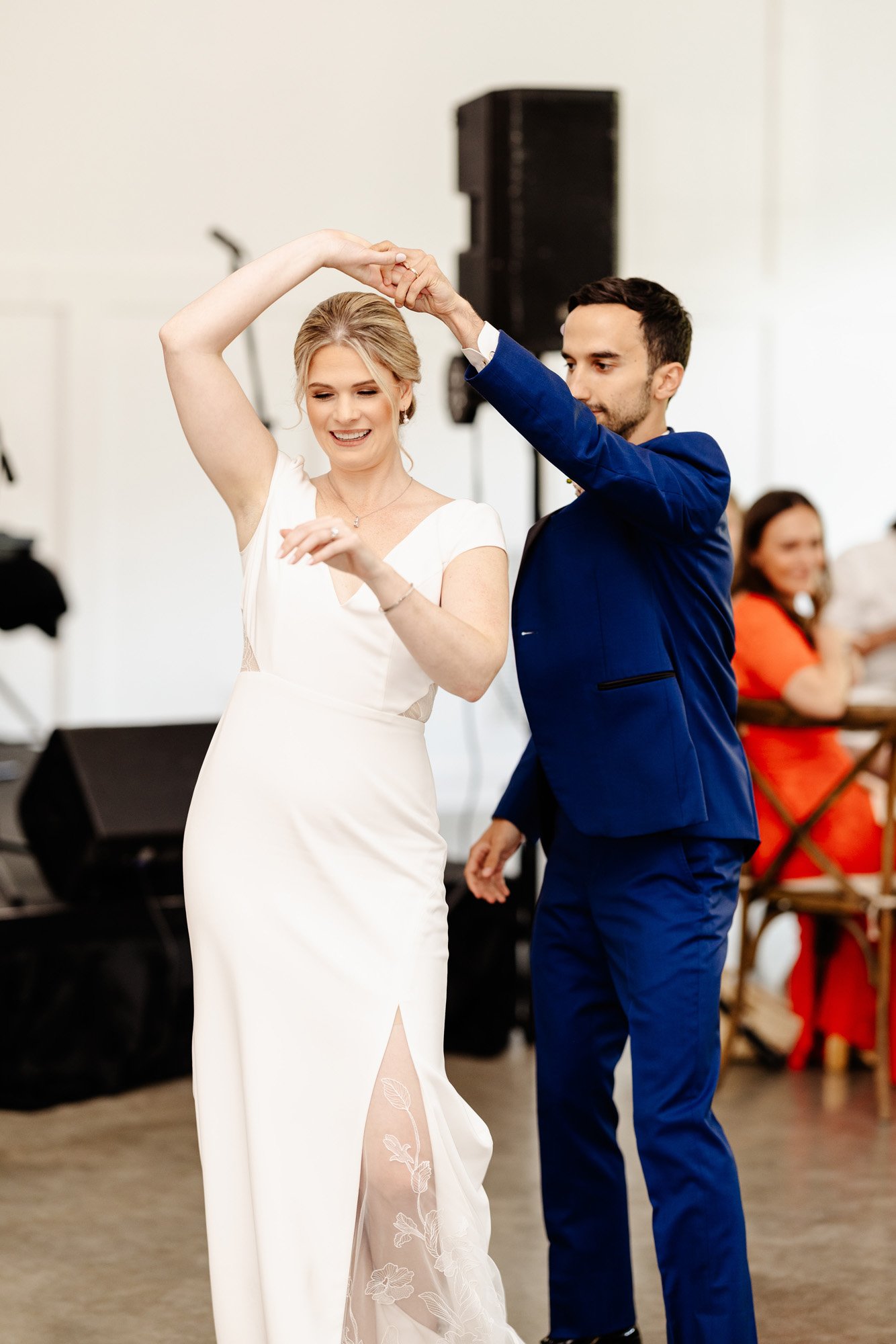 the bride and grooms first dance photo featuring a lace and crepe wedding dress by anais anette from a&amp;be bridal shop