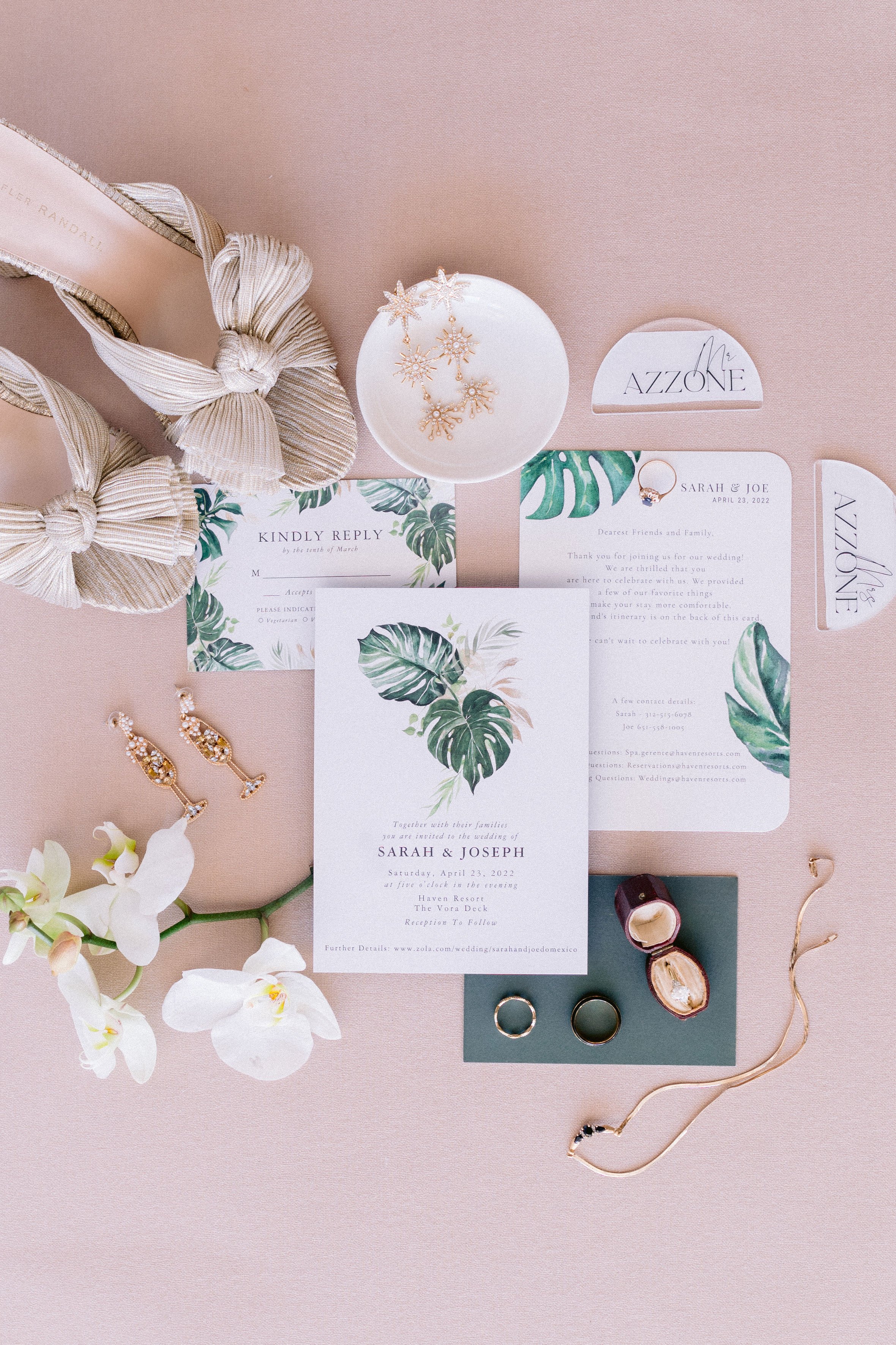 resort wedding details with a monstera leaf wedding invitation