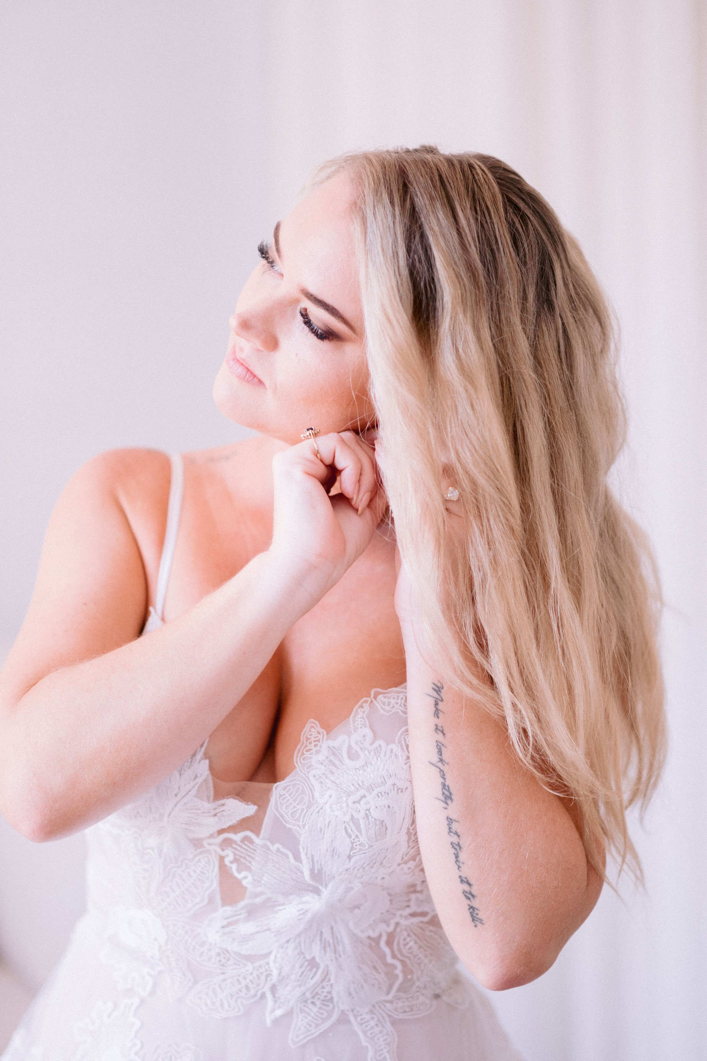 the bride getting ready in her flowy a-line madi lane wedding dress