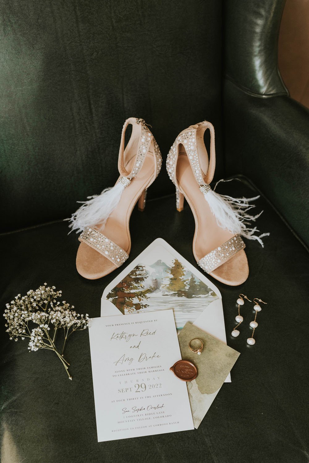  lovely blush bridal shoes with feather ankle ties, sparkle toe straps styled along side a rustic modern wedding invitation for kathryn and amy’s wedding featuring their watercolor mountain illustration envelope liner 