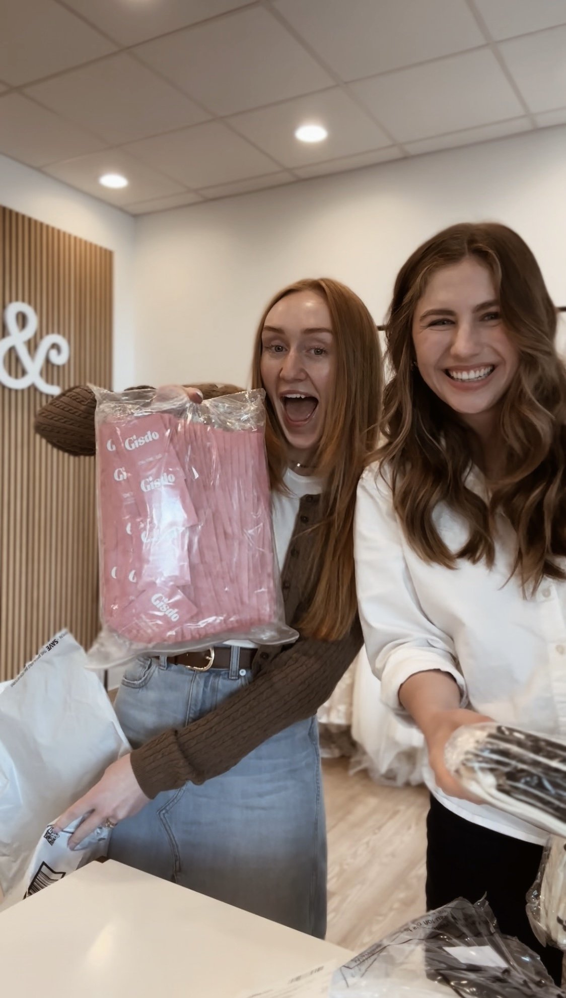  two girls creating period kits to donate to girls inc. each period kits consists of a tan, canvas bag, two flushable wipes, two tampons and two pads. 