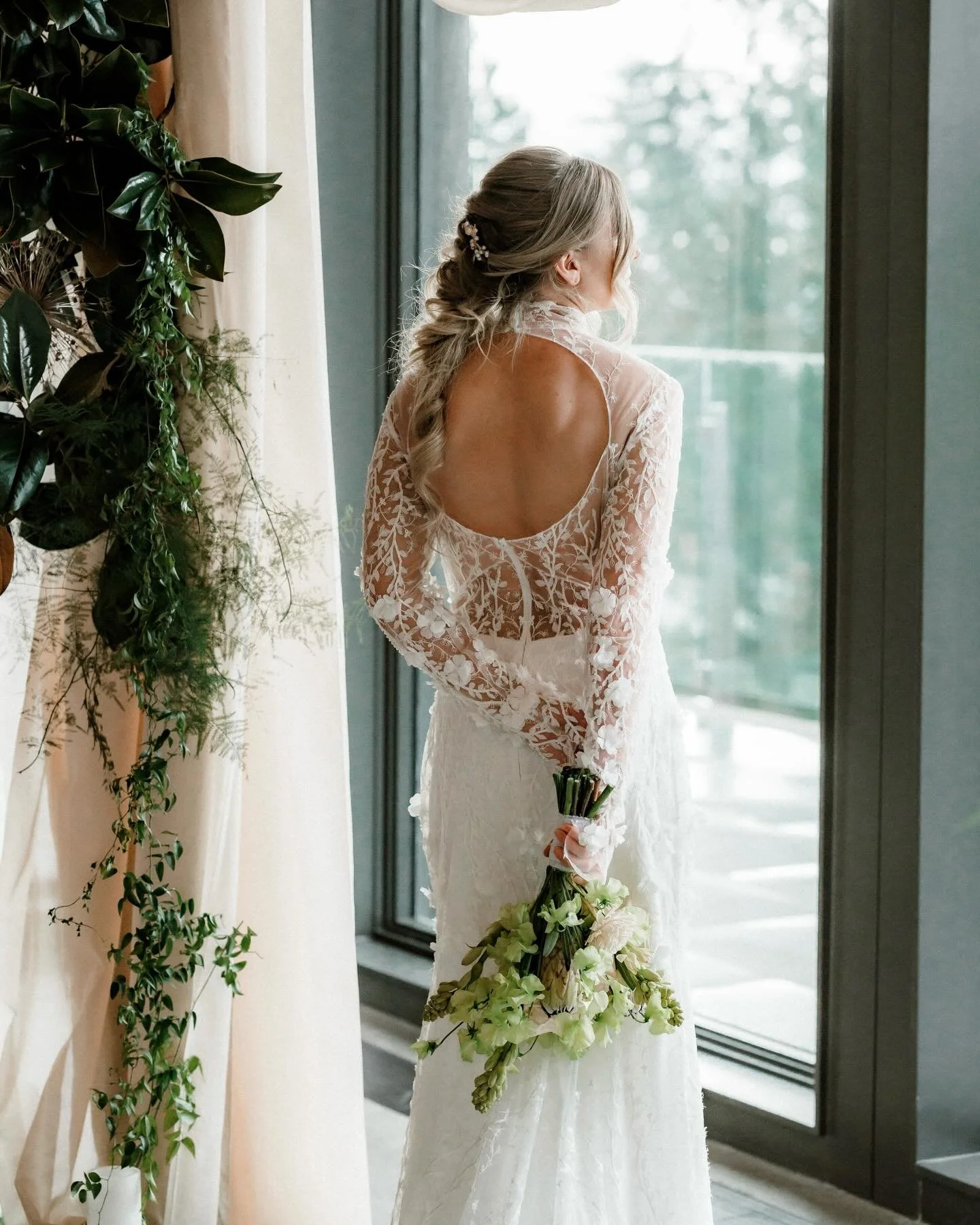 a high neck, long sleeve wedding dress from @saintbridal and shades of green &amp; warm candlelight? yes please ✨ this styled shoot was a real life winter garden party &amp; we are swooning over all the little details 😍

photo @dionnekrausphotograph