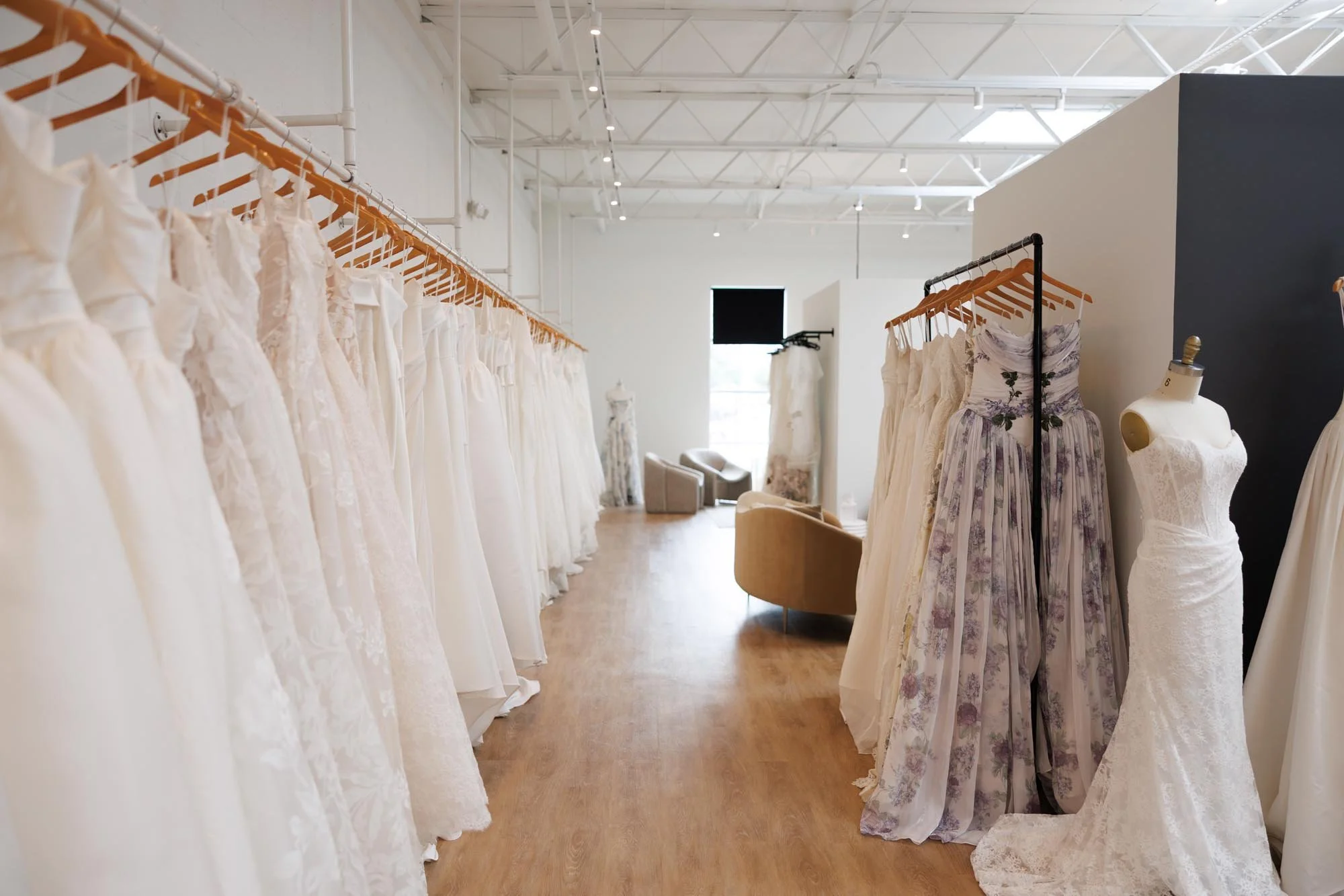 The interior of a&bé x anna bé bridal shop in Dallas, TX featuring wedding dresses and private bridal suites