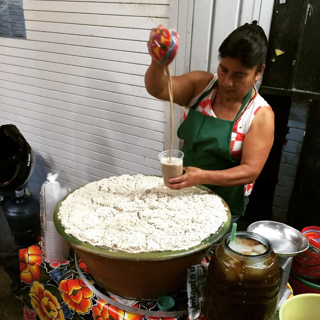 The traditional tejate drink being made by a skilled tejatera.