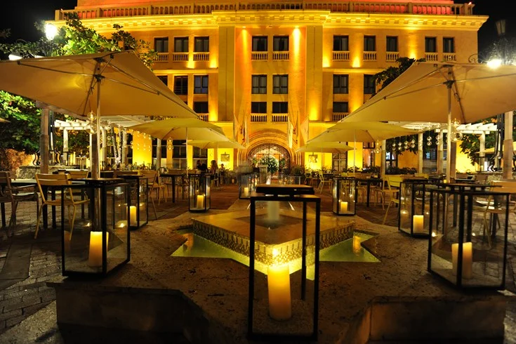 The front facade and open-air restaurant of the Charleston Hotel Santa Teresa