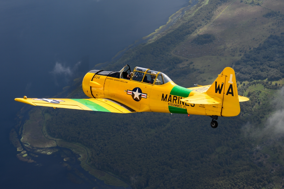 The lead T-6 turns over the lakes south of Kissimmee as my fellow photographer shoots back at us with a Nikon Z7