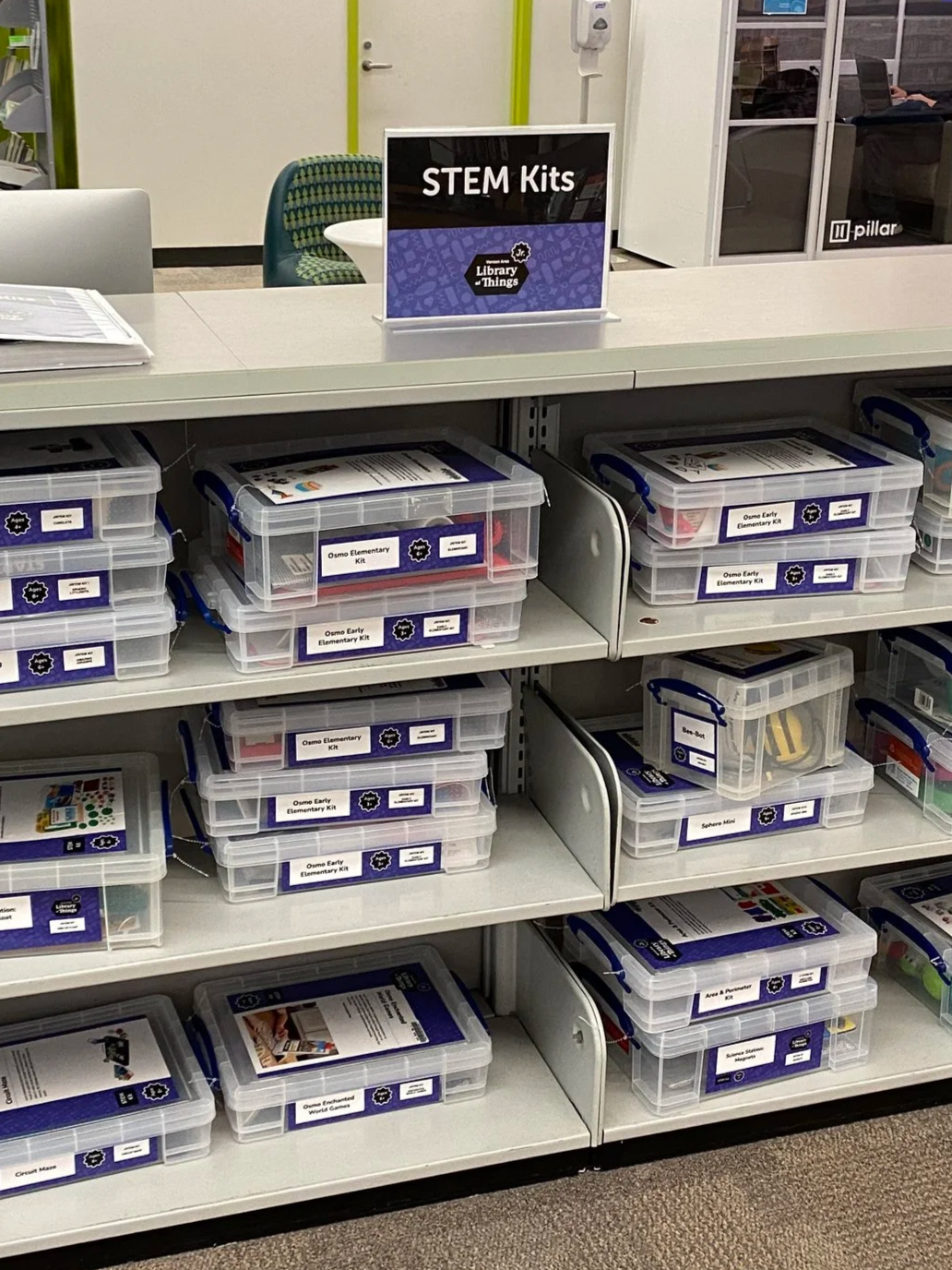 a shelf with boxes on it that says "STEM Kits"
