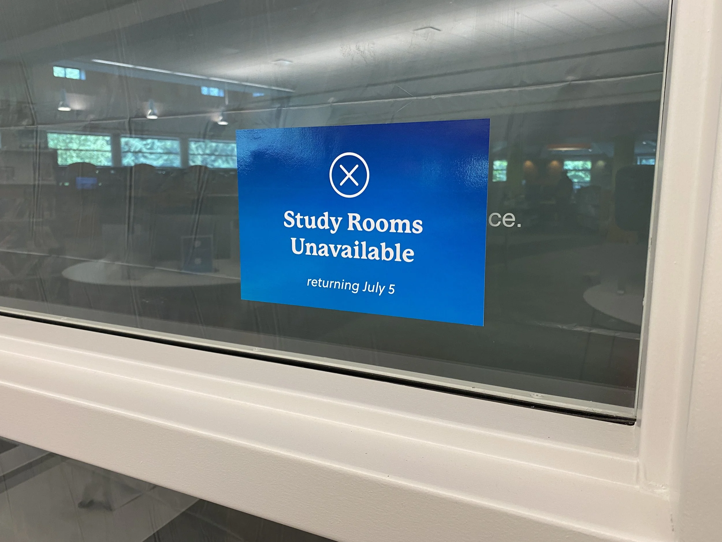 safety sign on a window that says "study rooms unavailable"