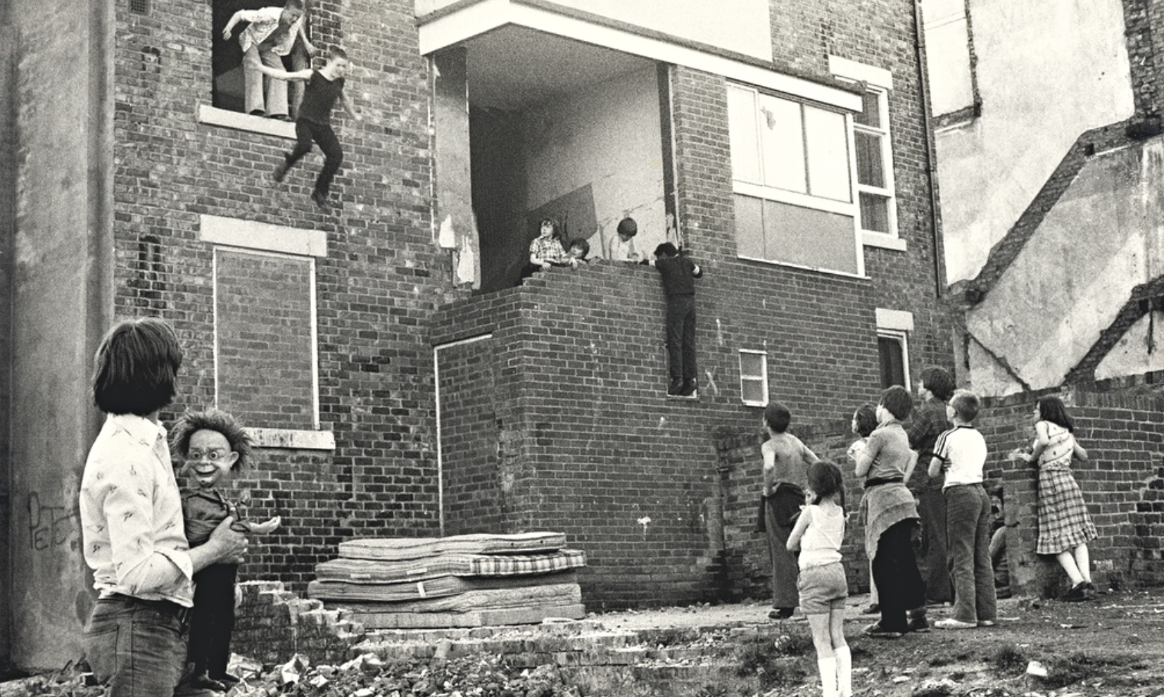 Glenn Murtha and his brother jump from a second-storey window. Photograph: Tish Murtha/AmberSide Collection
