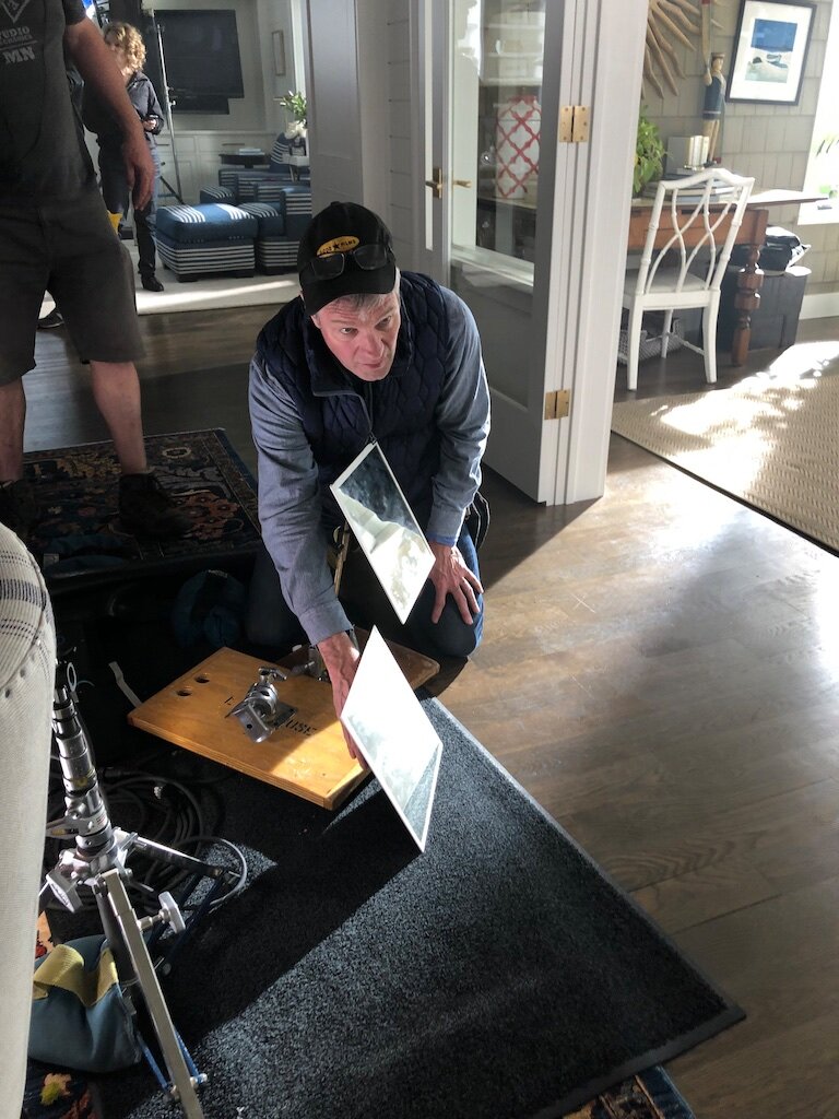 490 Gaffer Tom Franchett shines a reflector for the Marvin WIndows shoot.