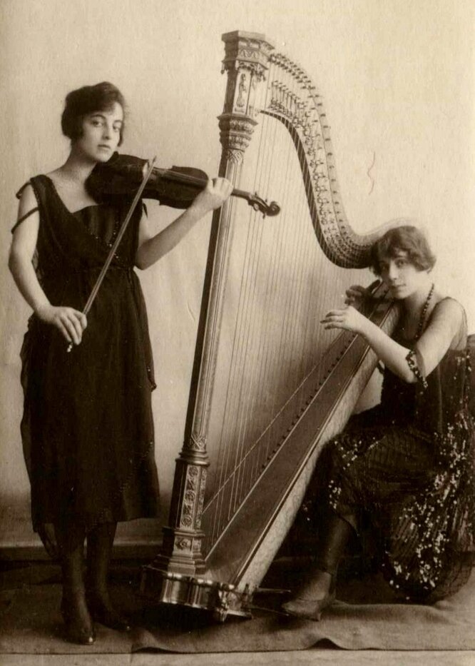 (c) New York Philharmonic Archives, courtesy of Doris Balant; 1918 concert promotion photo of Gertrude (left) and Steffy (right) with their respective instruments 