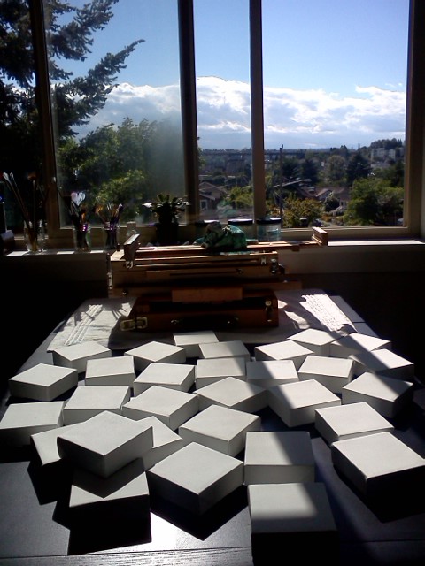 30 blank 4 x 4 x 1" canvases sitting on my table, waiting to be painted this month.