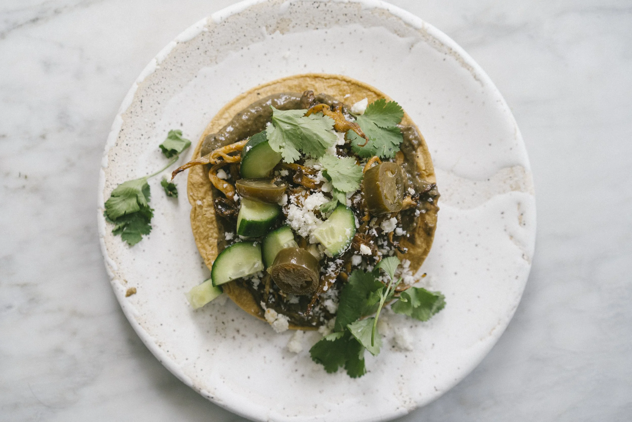 Pulled mushroom and black bean tostada&nbsp;