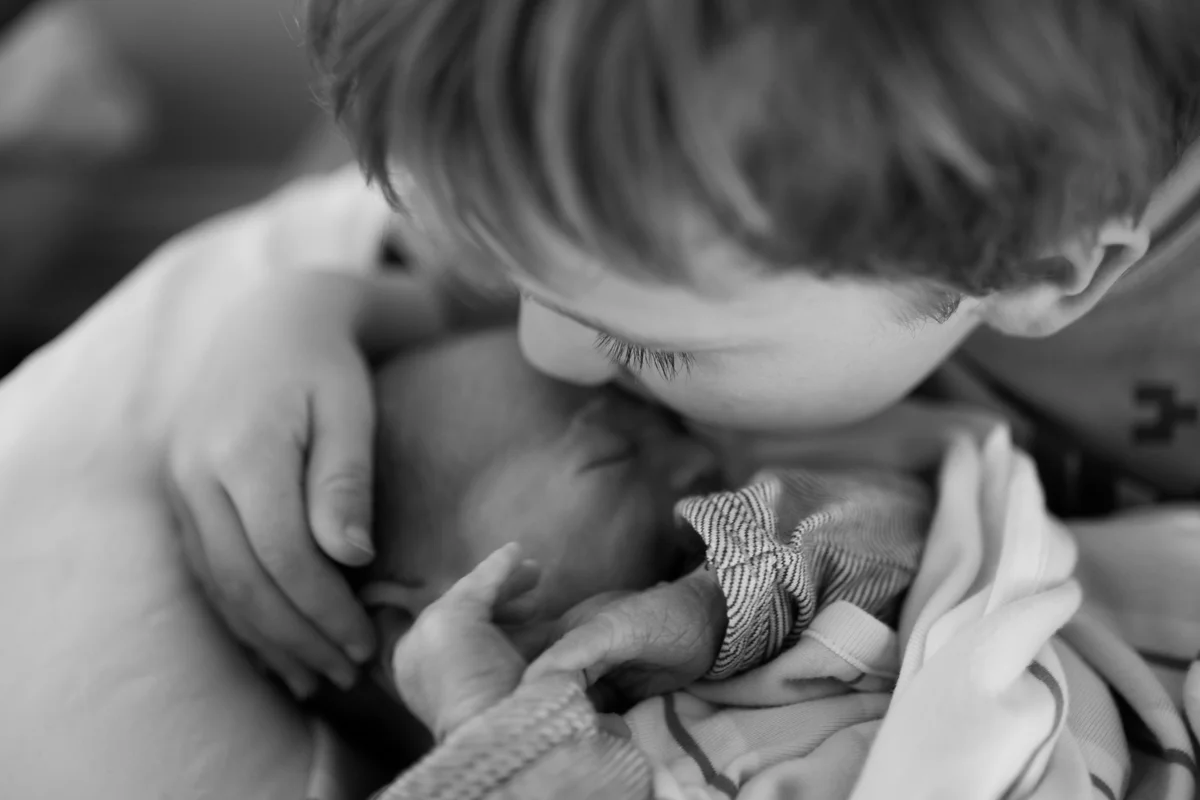 Mr. Eyelashes giving his little bro a kiss...