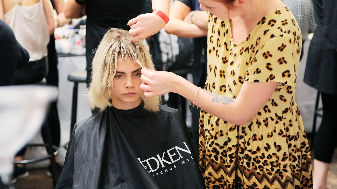 Cara Delevingne getting a trim backstage at Marc Jacobs SS14