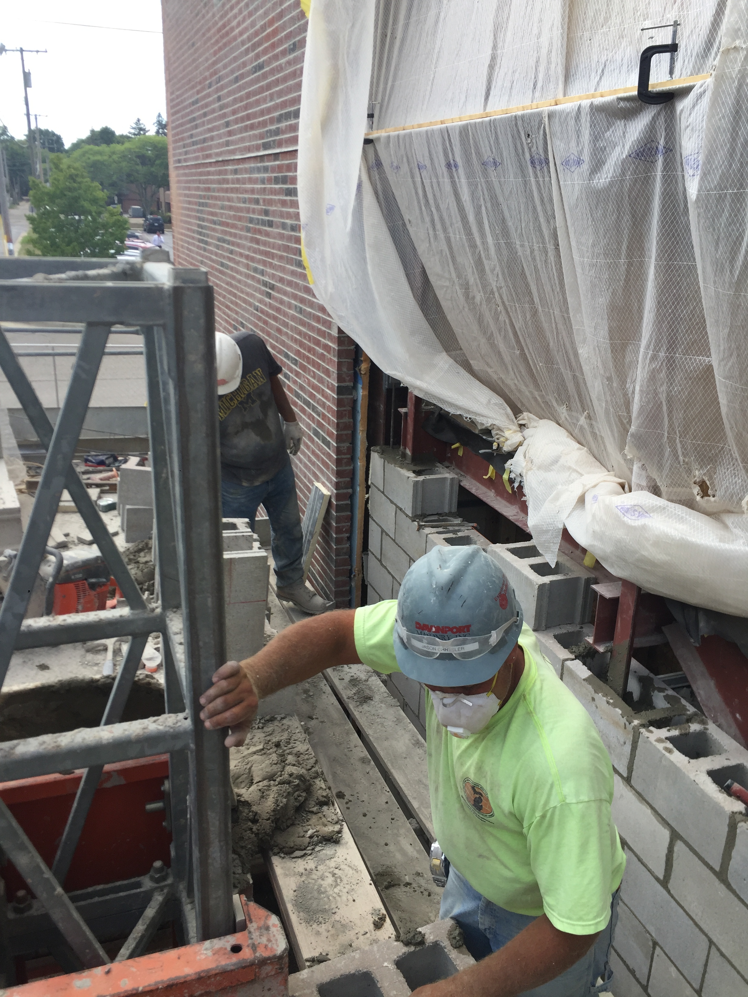Masons installing new brick.