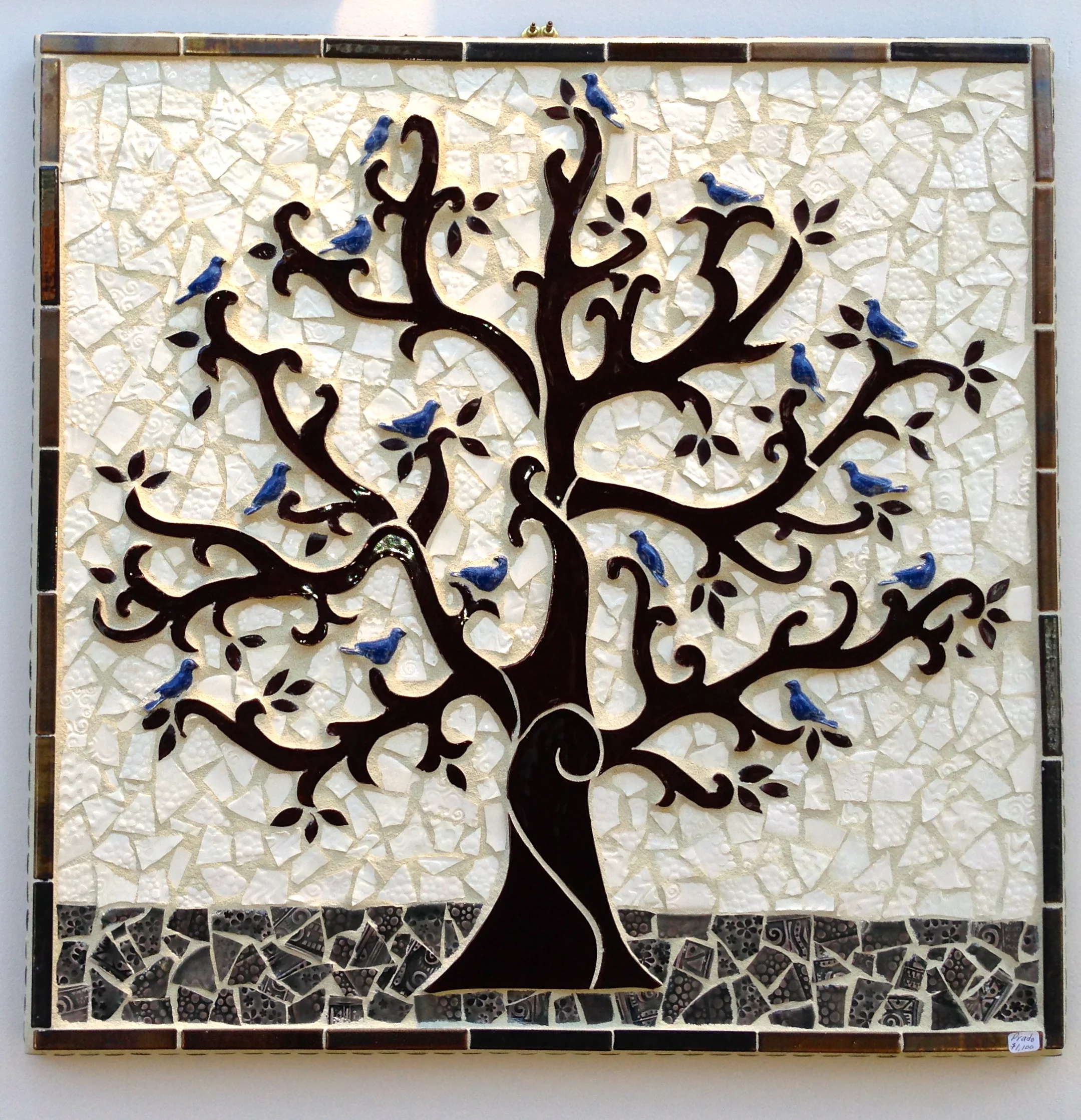 Resting Place 25" x 25" features a resting flock of blue birds in a tree of life with richly textures background tiles framed in antique golden stone.