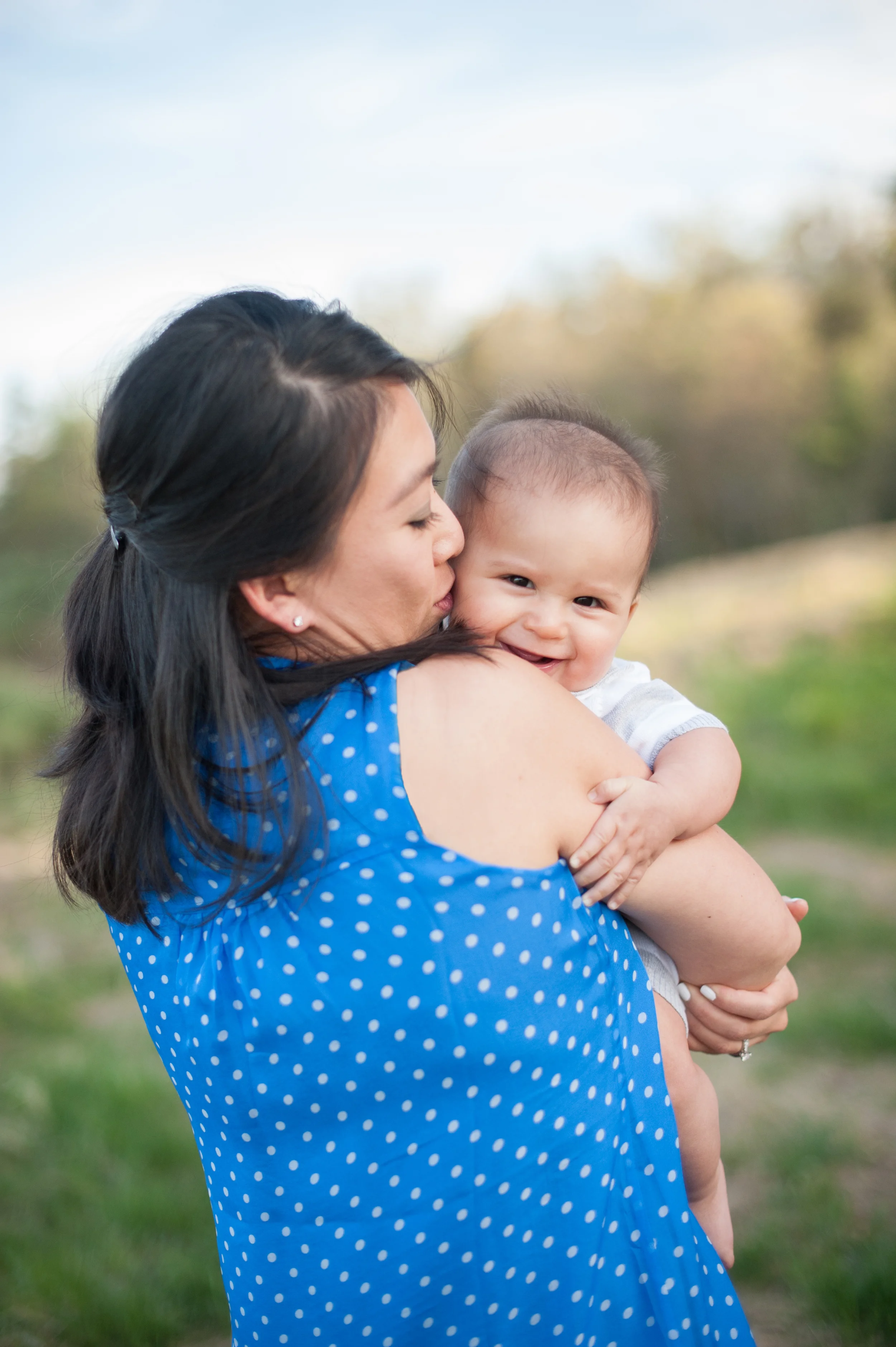 I love this shot. Ngoc's shirt popping against the green backdrop is so striking and Tyler grinning while peeking around and receiving kisses from Mommy is too much. See, he' just so cute. 