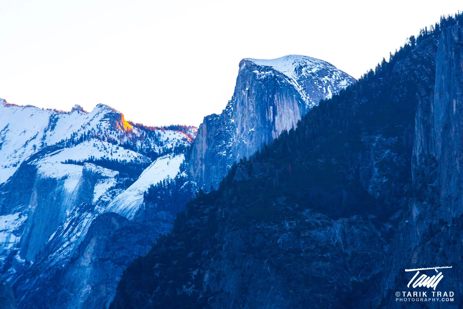 Half Dome at sunrise with the first rays of the day striking Clouds Rest to the east.