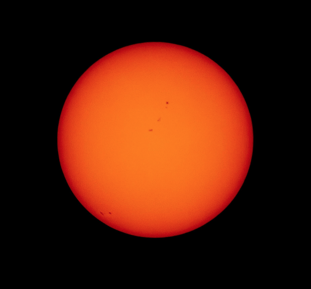 My Before shot of the sun. Note the sunspots in the center and bottom left. FYI - the sun appears orange in these images due to the darkness of the solar filters used on the camera lens.