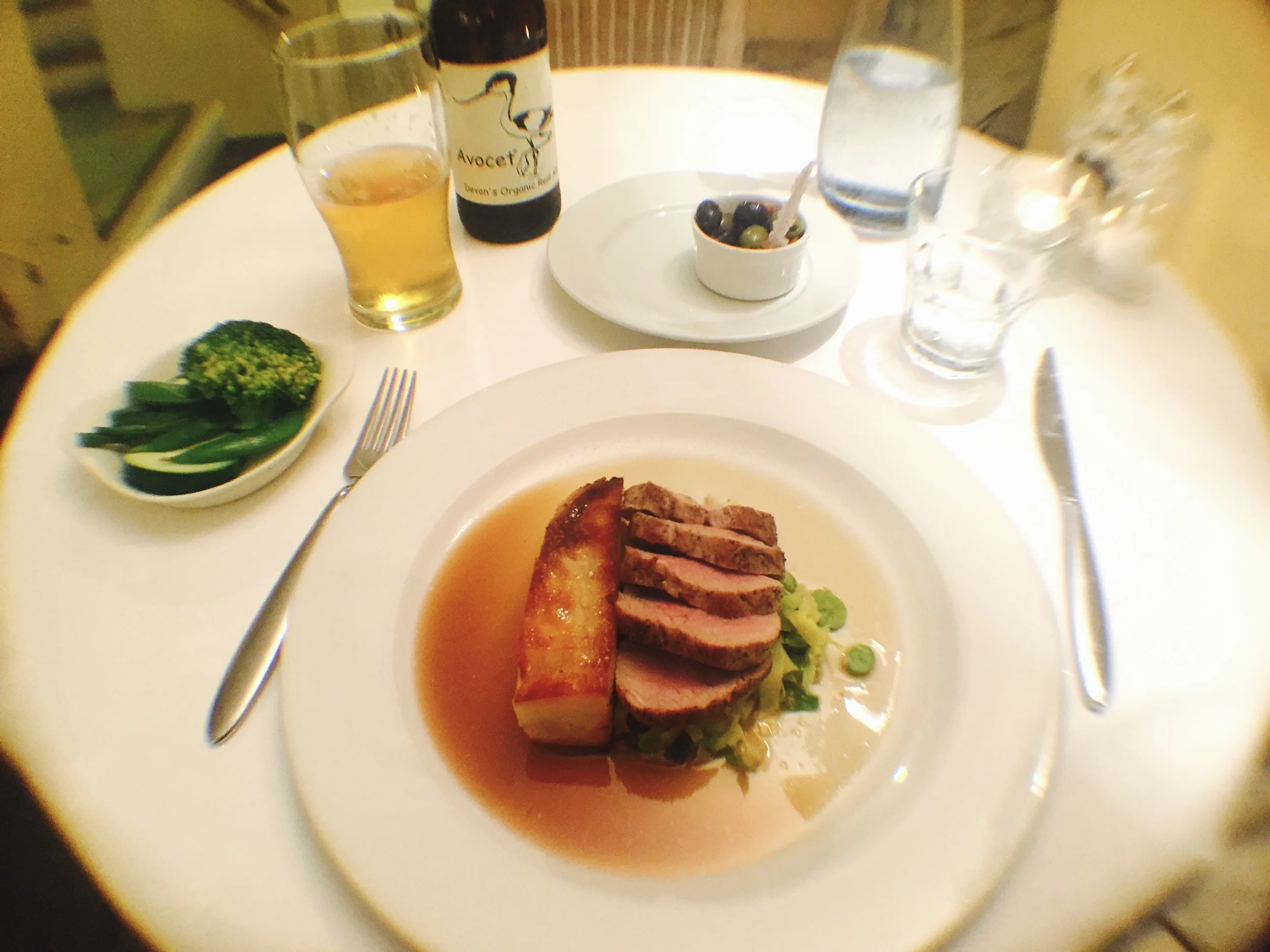 Roasted pork tenderloin, broad bean and spring cabbage, dauphinoise potato, calvados sauce and fresh green vegetables