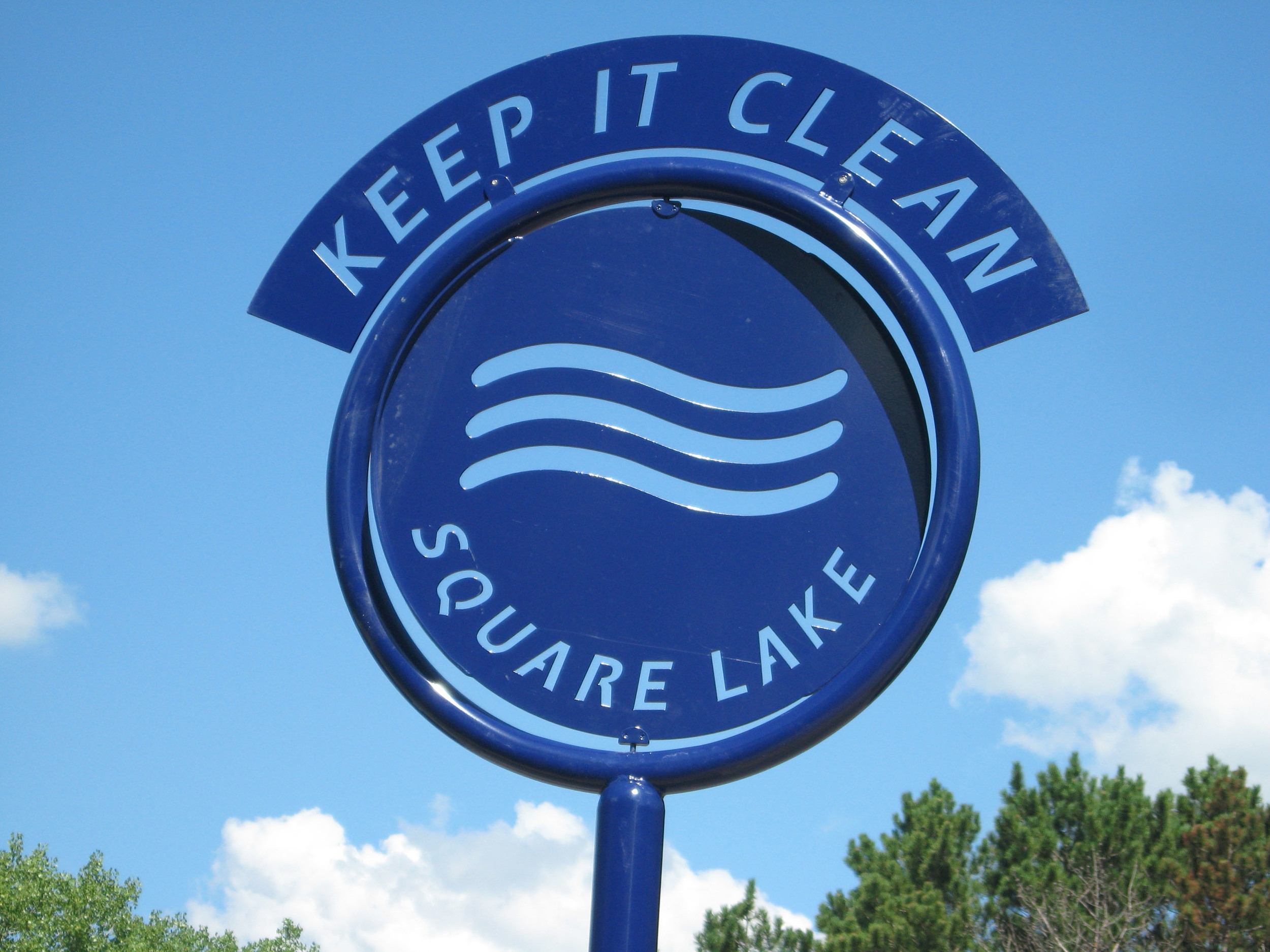 A sign marks a new demonstration project to reduce runoff from the parking lot at Square Lake Park.jpg