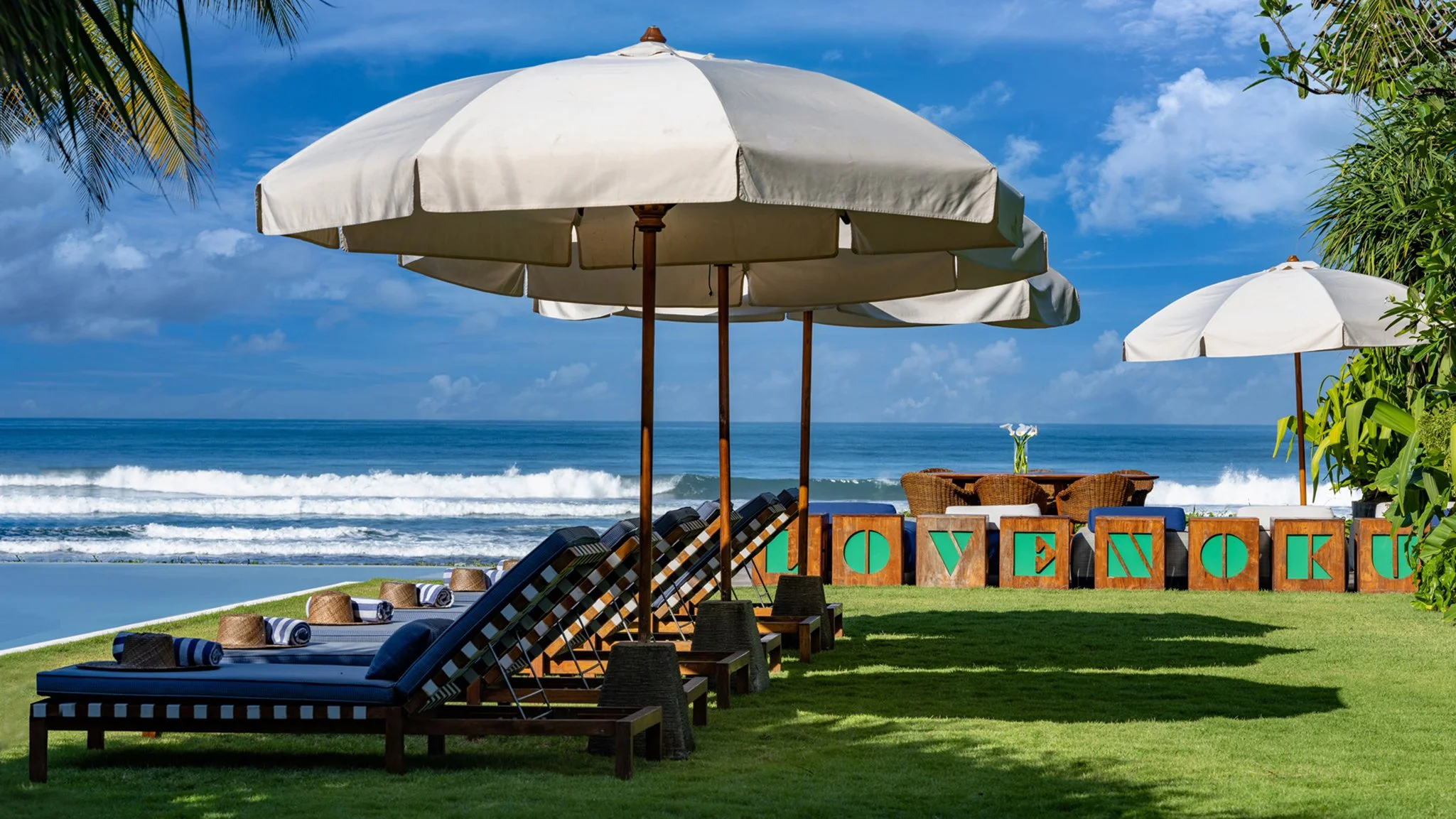 008 Noku Beach House - Sunbrellas by the pool.jpg