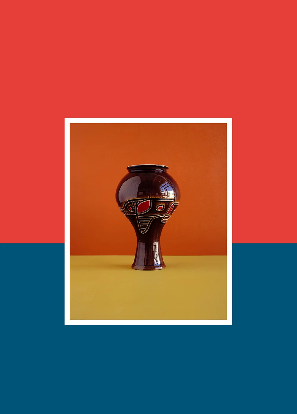 Africana 2016 Mixed technique, color photography, inkjet print and paint on wall (Print size: 130x170 cm / Work size: 230x320 cm) In 2003, David Adika presented “Mahogany,” a series of 11 photographs of wooden statuettes from Africa that decorated his parents’ living room. His father had brought them from his travels to Africa—small sculptures of animals made of pale wood and painted black, sold as souvenirs. Adika photographed them on a glossy black surface, with dramatic lighting, seeking to echo the domestic sideboard, and printed the photographs in a large format, thus providing the African souvenir statuettes with a magnificent, monumental representation. The title “Mahogany” further imbued them with the opulence of the expensive wood (which has nothing to do with them) and hinted at a pun: the Hebrew word for “mahogany” can be read as “what is my color?” The question which Adika raised about the statuettes as well as about himself made the first link in Israeli art between the African black and the relative blackness of Oriental Israelis, thus diverting along the way the post-colonial discourse to the local, ethnic context. The series “Africana” continues Adika’s ongoing interest in objects as identity conductors and in still life as the continuation or replacement of the body as a political entity. At the core of these new photographs is commercial glazed ceramic tableware made in Israel in the 1950s, 1960s and 1970s by companies including Na’aman, Lapid, Palceramic and Beit Hayotser, in the attempt to create an authentic Israeli material language. The tableware, generally known as “Israeliana,” eventually lost its attraction due to, among other reasons, its identification with archeology, ideology and the fascination with the idea of a “homeland,” as well as changing tastes. Today it can be found in flea markets—usually slightly faulty or broken—where Adika purchases the pieces, building himself a collection of Israeliana in earthen hues, with the esthetics of Modernism identified with Israel’s early decades. When he photographs them against a background of wooden panels painted in complementary colors, he extricates from these vessels the layers of African influence that have not been elucidated so far, nor noted in the consciousness: the shapes, colors, design. He photographs the tableware singly, in pairs and in groups, and only a slight change of perception is needed in order to transform it into staged studio portraits. Adika makes a double move here: he presents the formalist aspect of the 1984 MOMA exhibition “Primitivism in 20th Century Art: Affinity of the Tribal and the Modern” and annexes to it the insights of post-colonial discourse. The photographs show how the new, modern-western Israeli identity often adopted, not necessarily consciously, an African esthetic—exotic and authentic rootedness in the guise of Modernism. Curator: Ruth Direktor, TLV Museum 2017