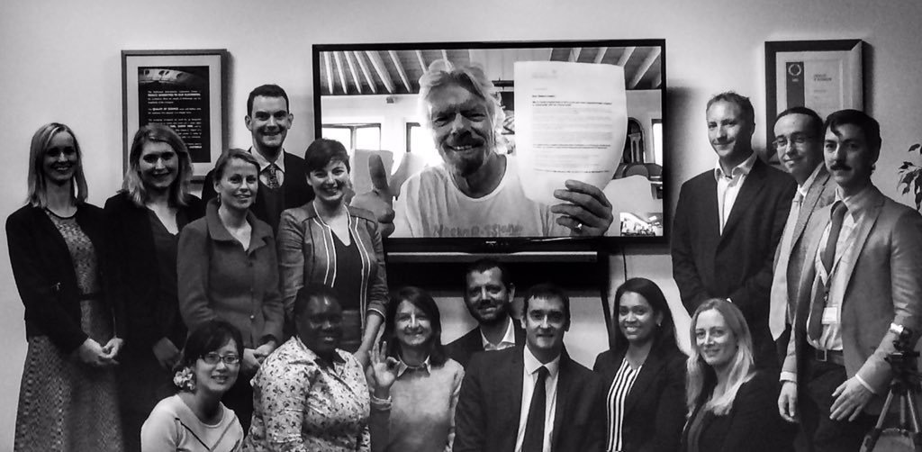 FORUM ATTENDEES pose with sir richard branson, who holds the letter addressed to delegates of cop21 . photo courtesy of the world forum on natural capital. 