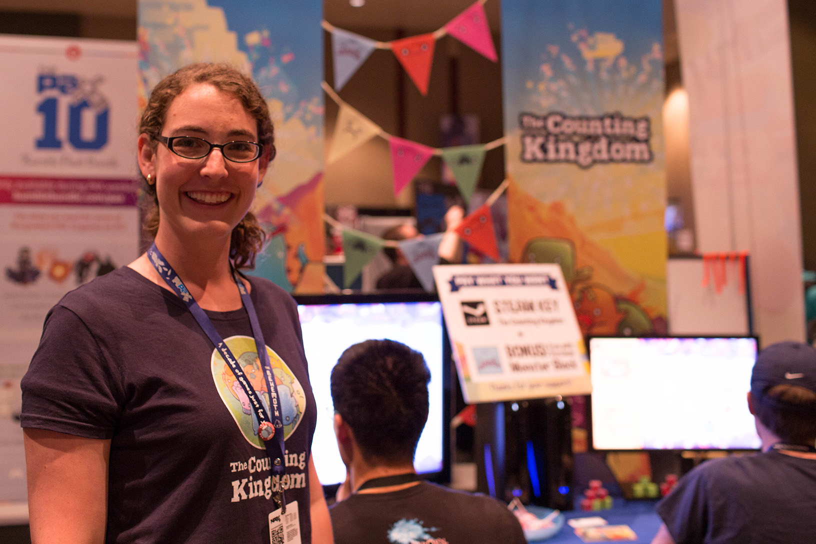 Founder Jenna Hoffstein stands in front of The Counting Kingdom table at PAX Prime 2014