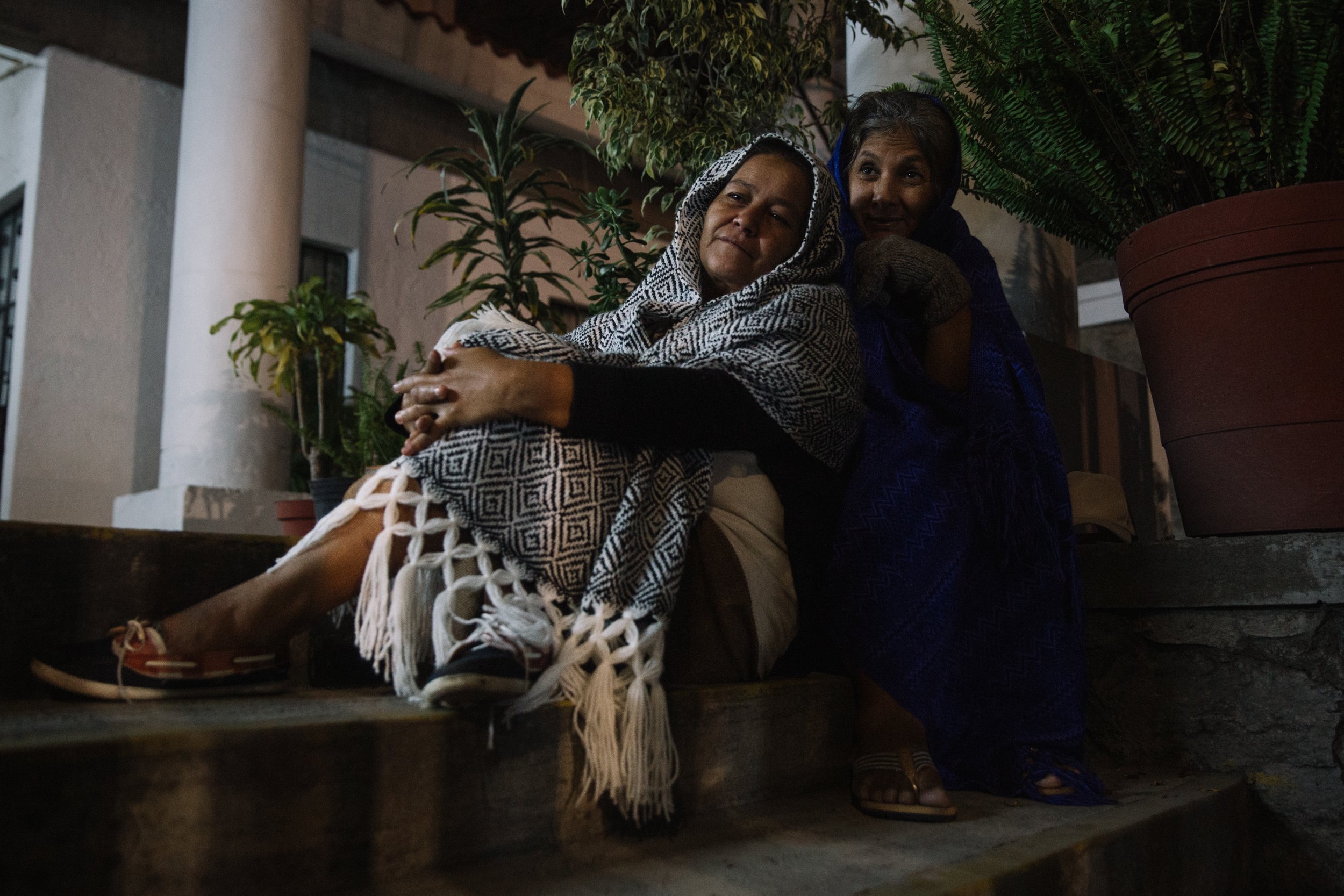  Skipping mass, Guadalupe Mendoza bundles up with another mother at Parroquia Nuestra Señora de la Asuncion in Puebla, Mexico. While the mothers attend special masses in honor of their missing loved ones, they often find solace and friendship in each